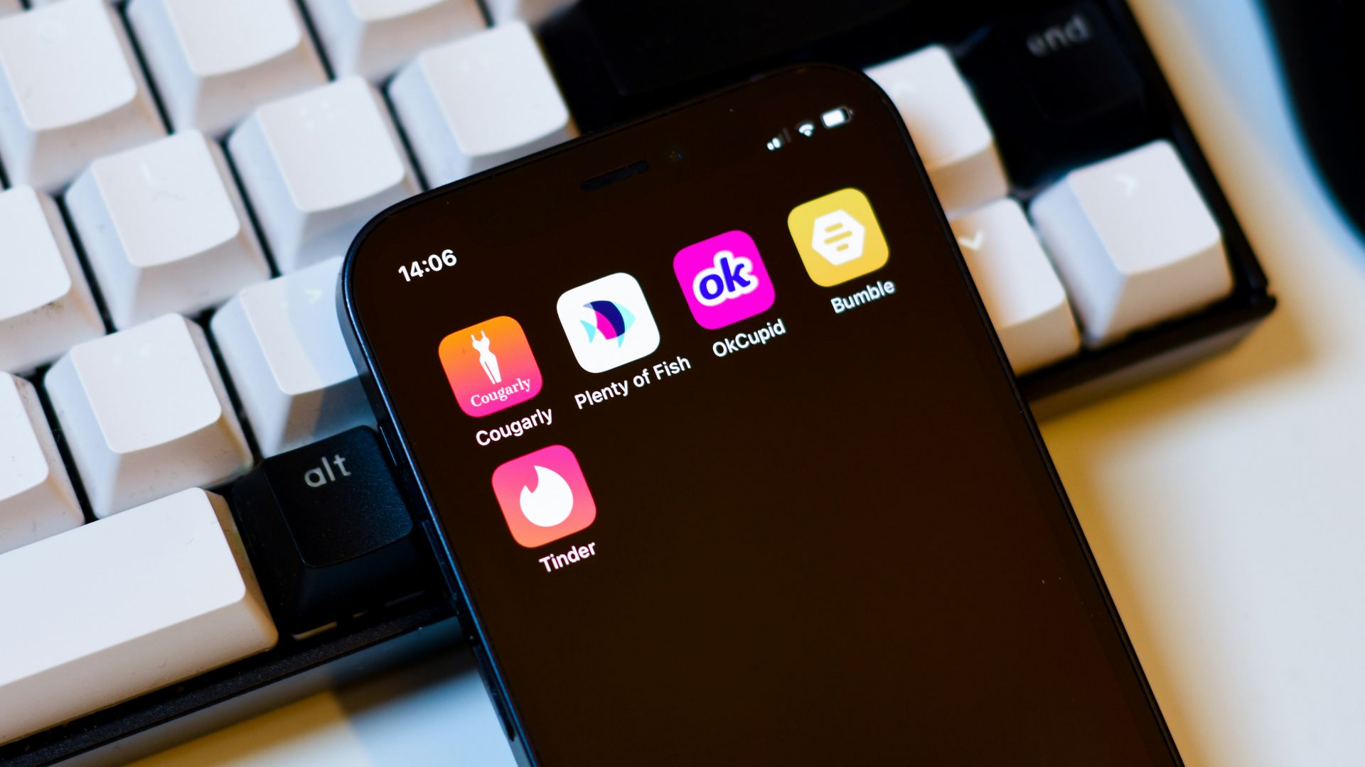 a cell phone sitting next to a keyboard