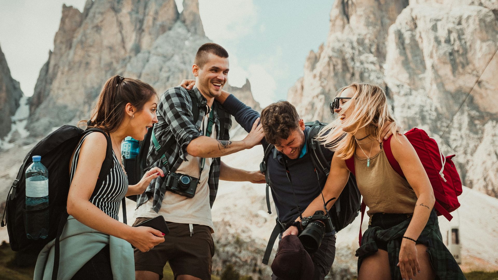 low-angle photography of two men playing beside two women
