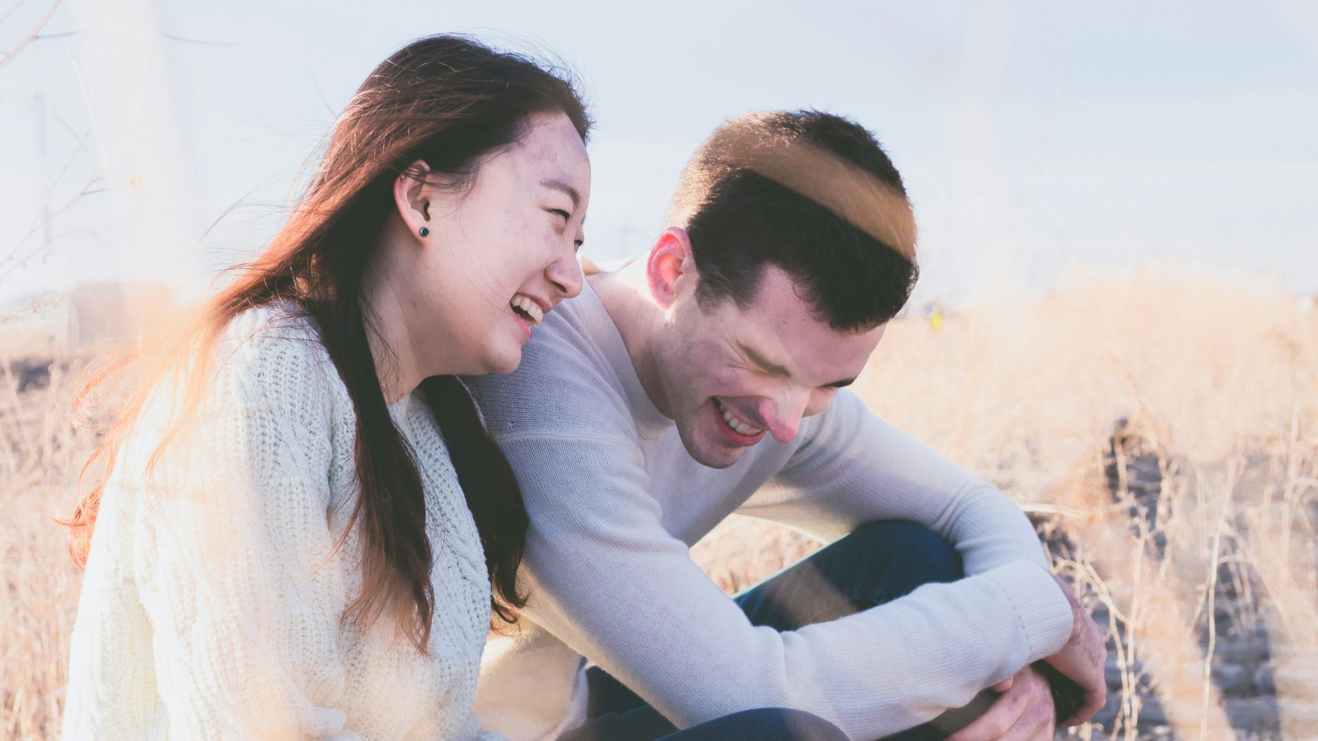photo of man and woman laughing during daytime