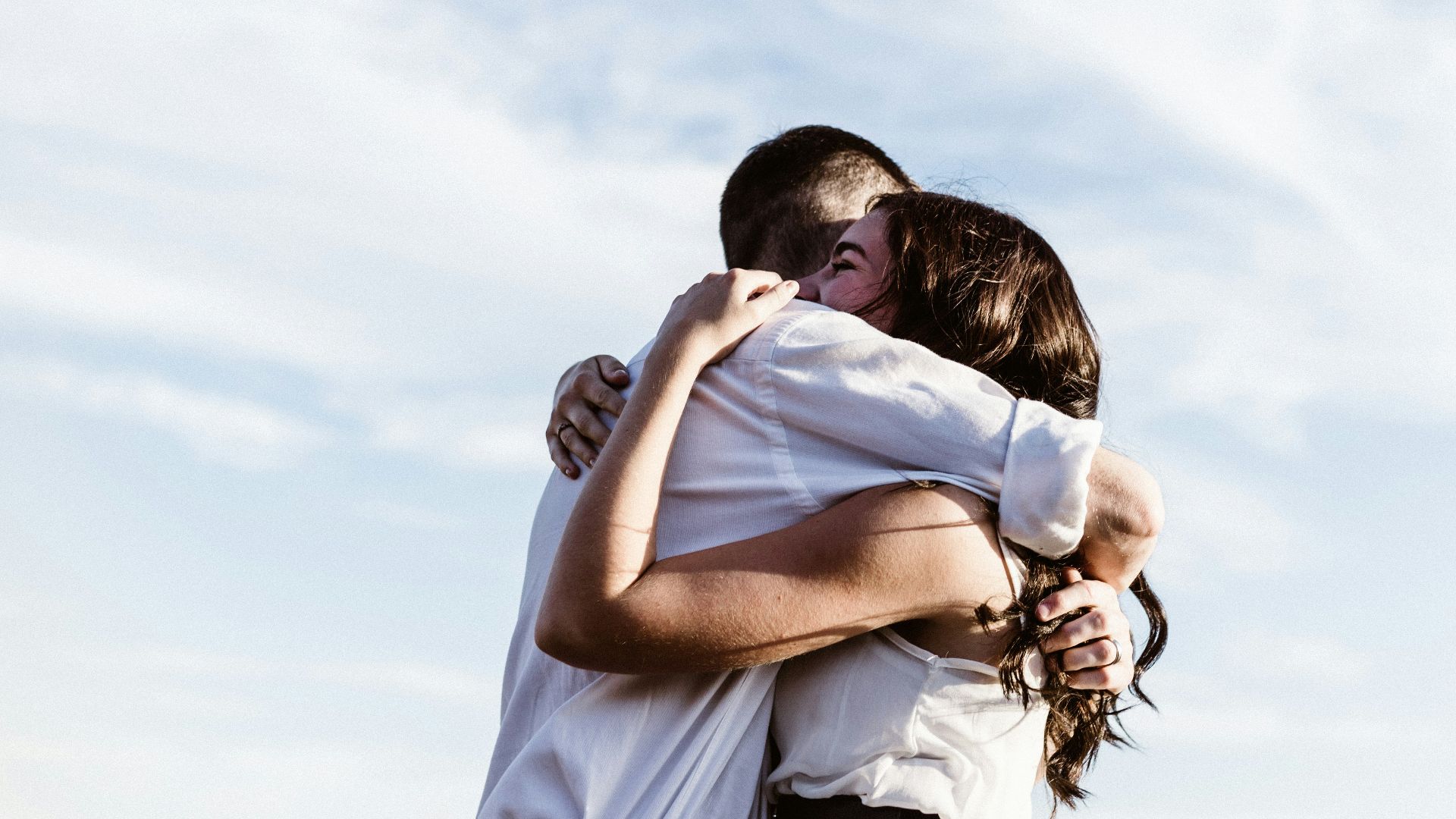 man and woman hugging each other photography