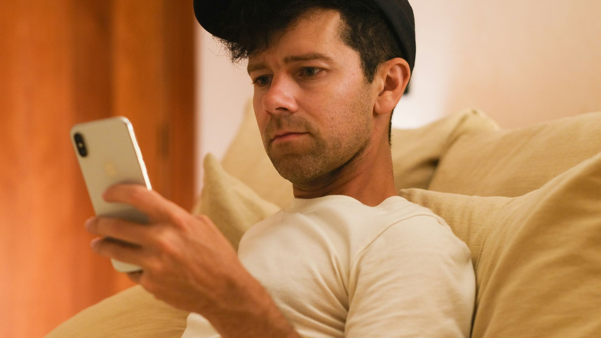 A man is focused on his phone.