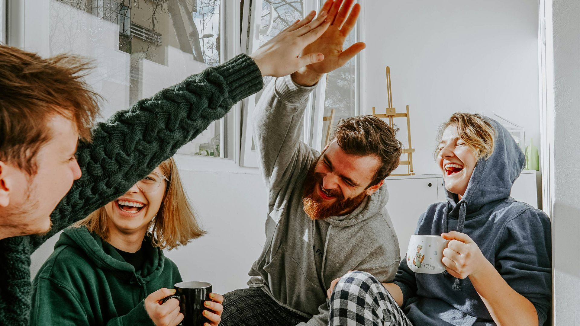 woman in black and white checkered long sleeve shirt sitting beside man in green crew neck