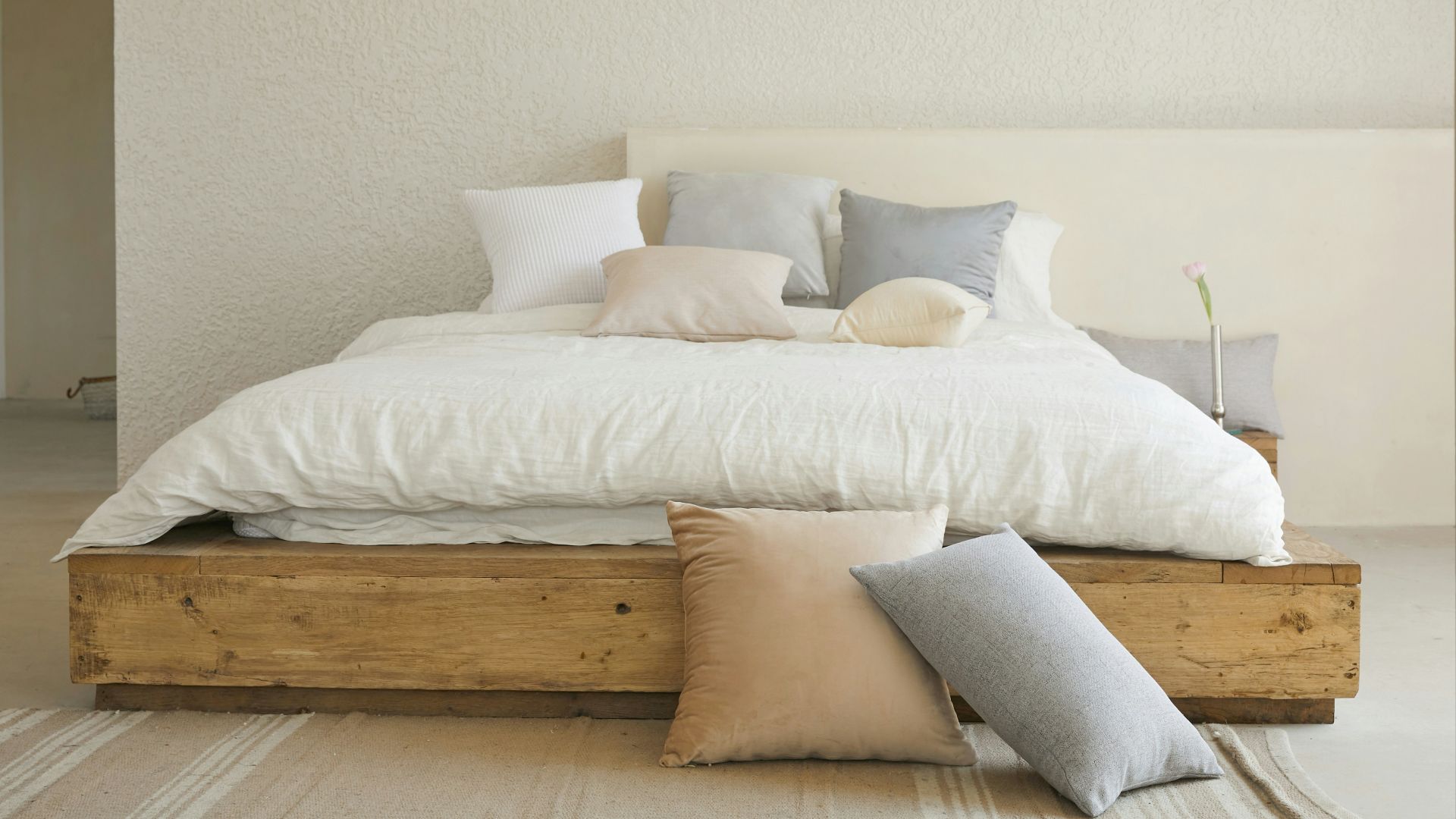 white bed pillow on brown wooden bed frame