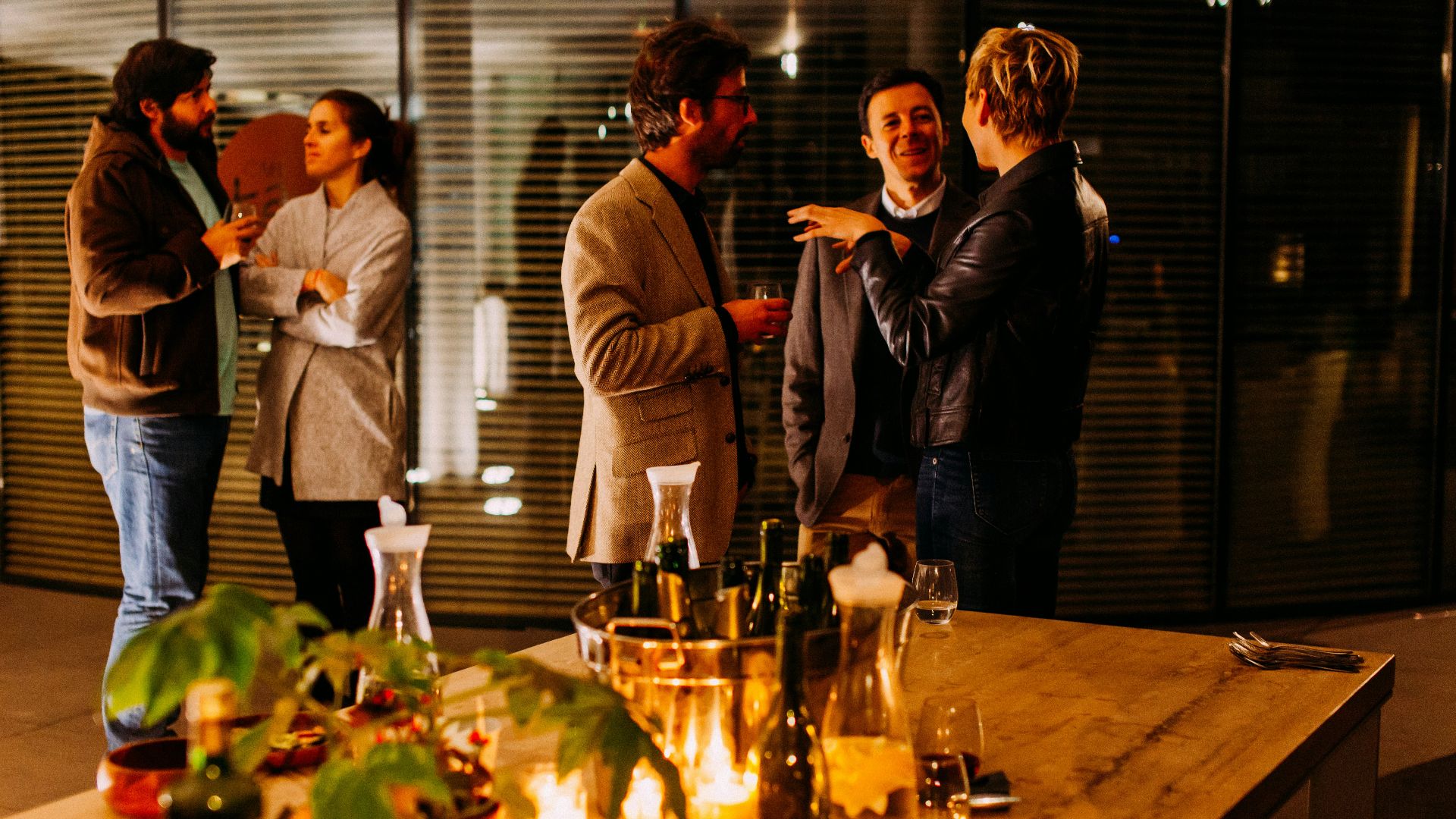 five person standing while talking each other