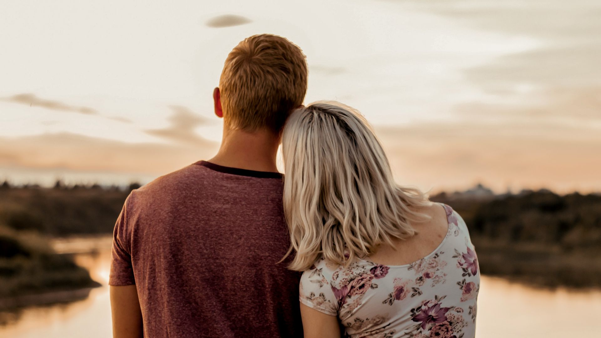 man and woman standing on brown field during daytime