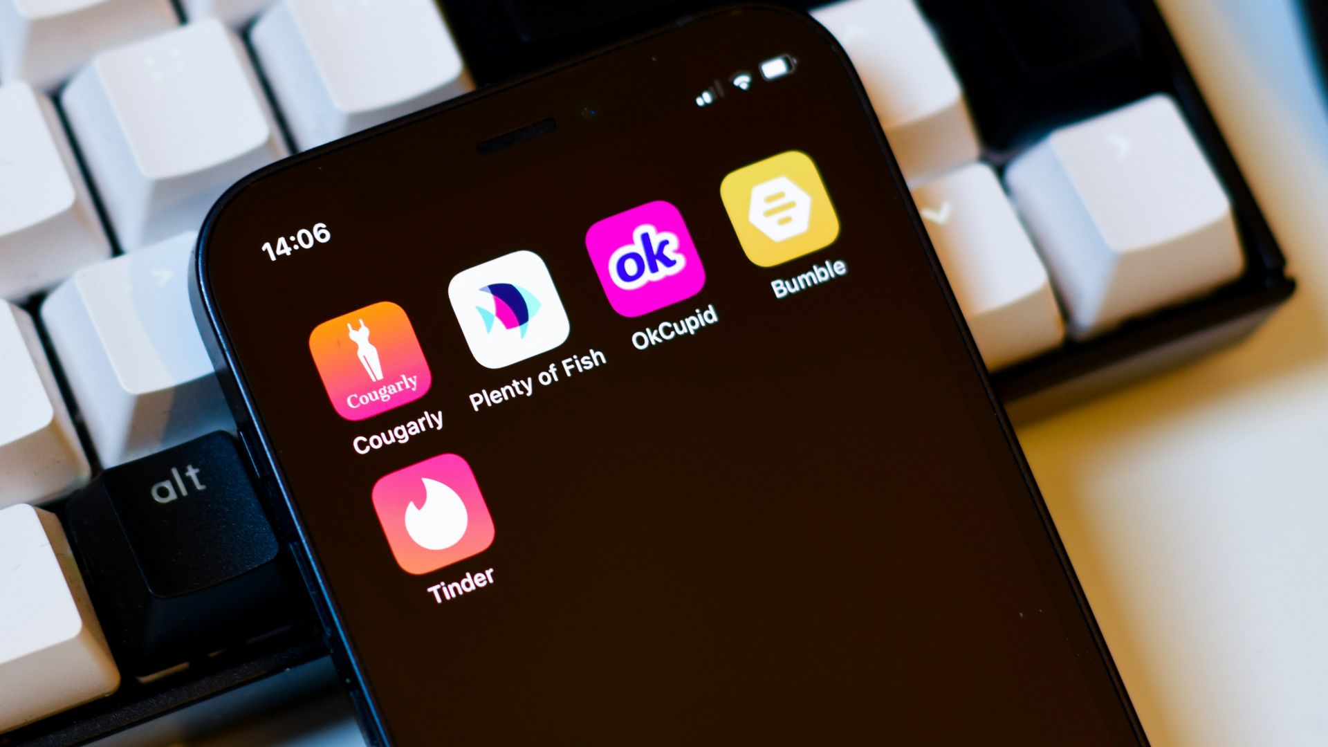 a cell phone sitting next to a keyboard