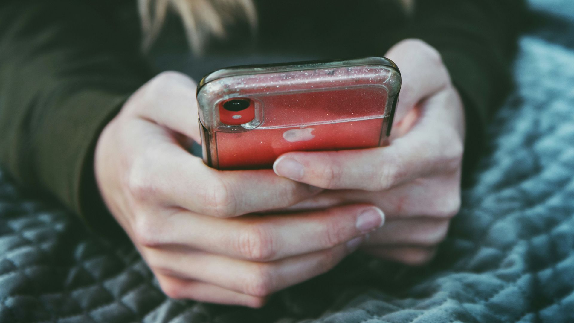 woman holding red and silver can