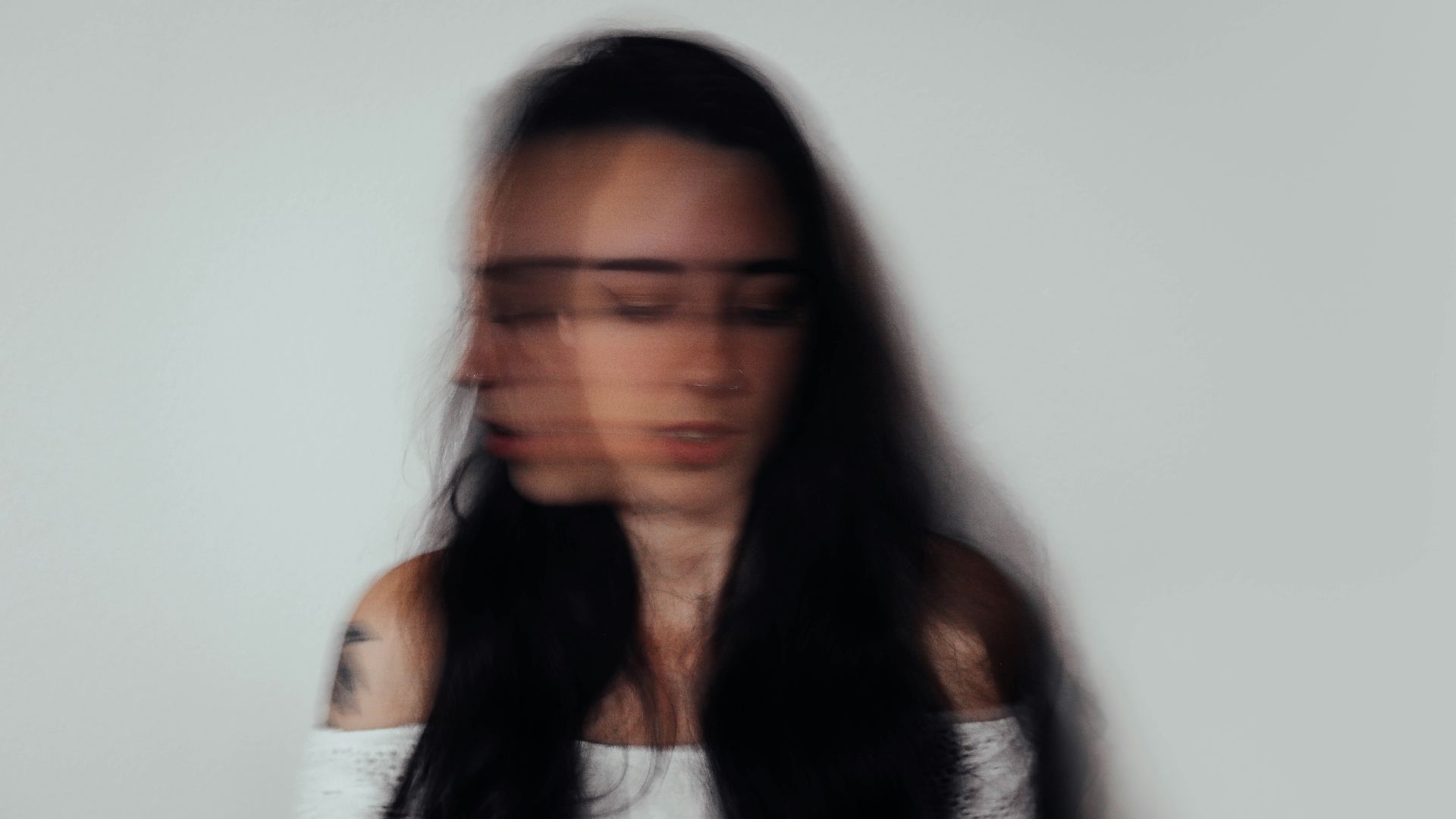 a blurry photo of a woman with glasses