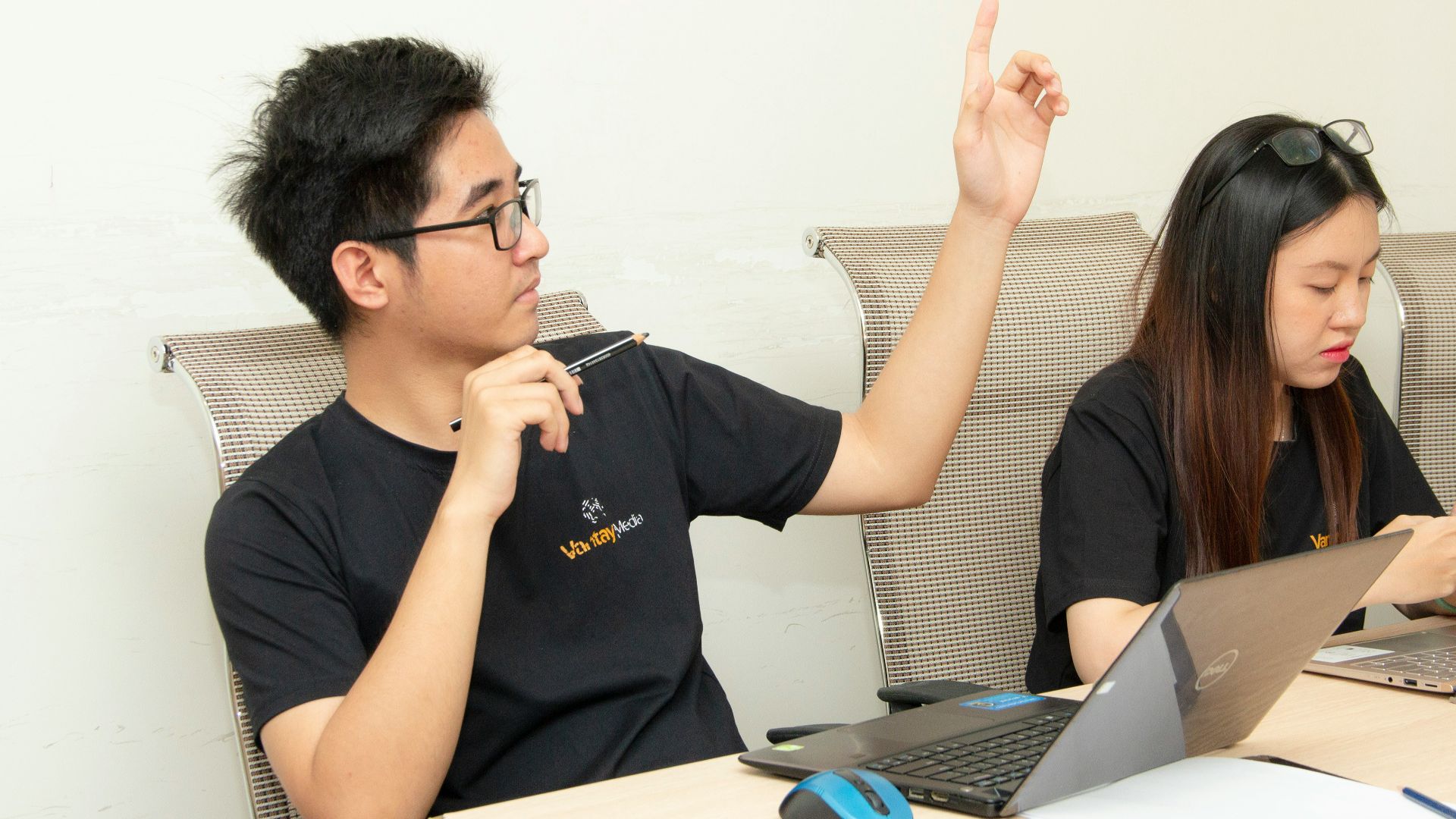man in black crew-neck shirt sitting beside woman