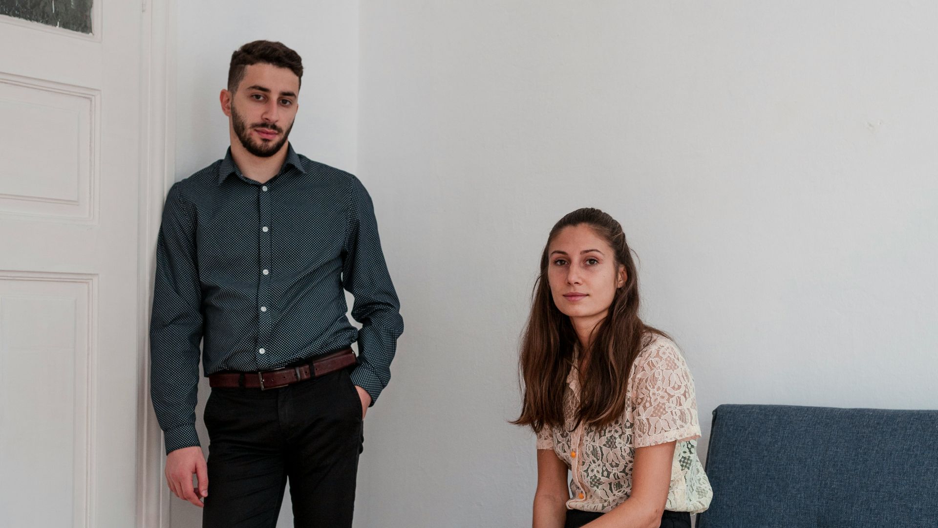 standing man beside sitting woman