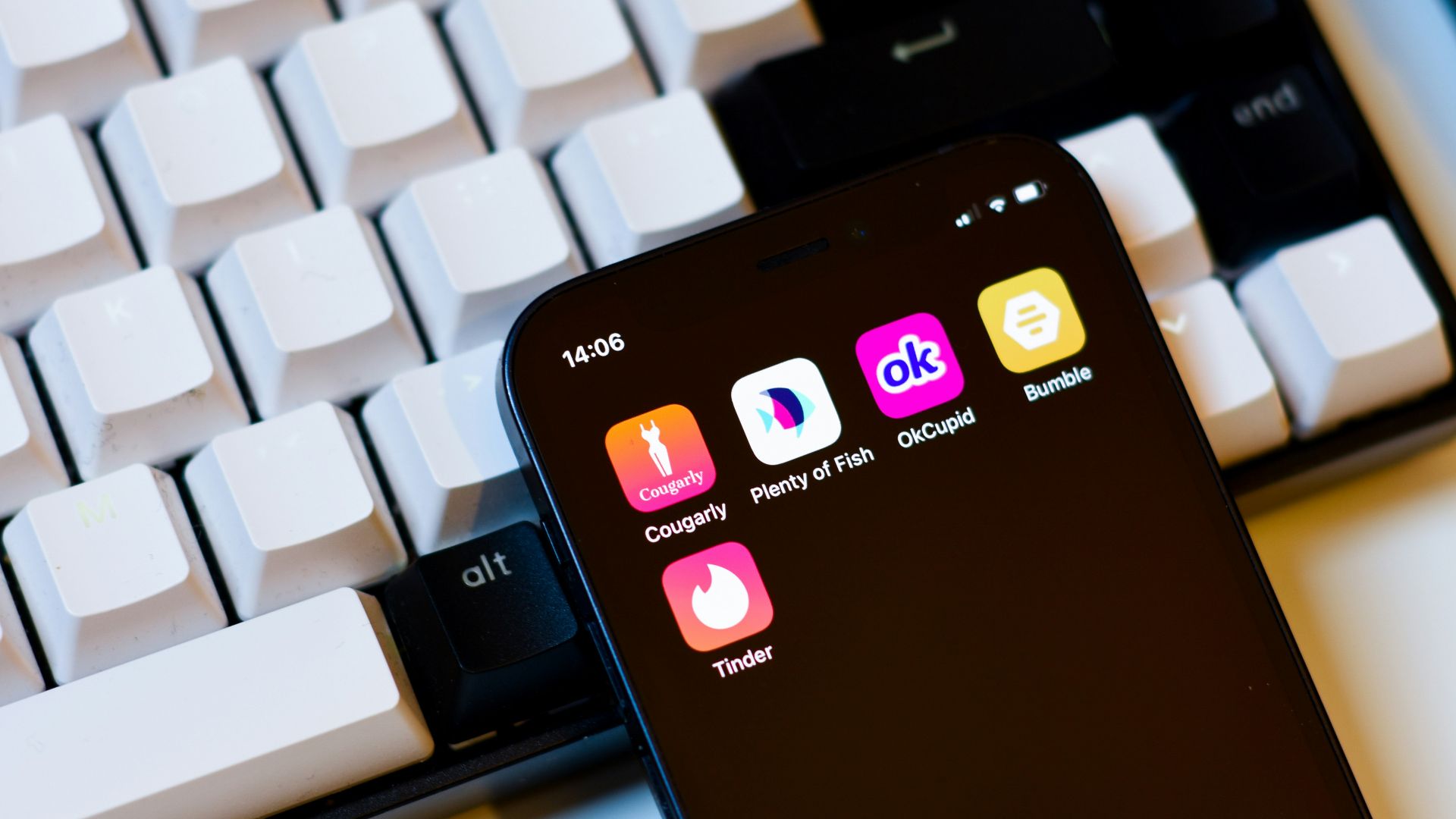 a cell phone sitting next to a keyboard