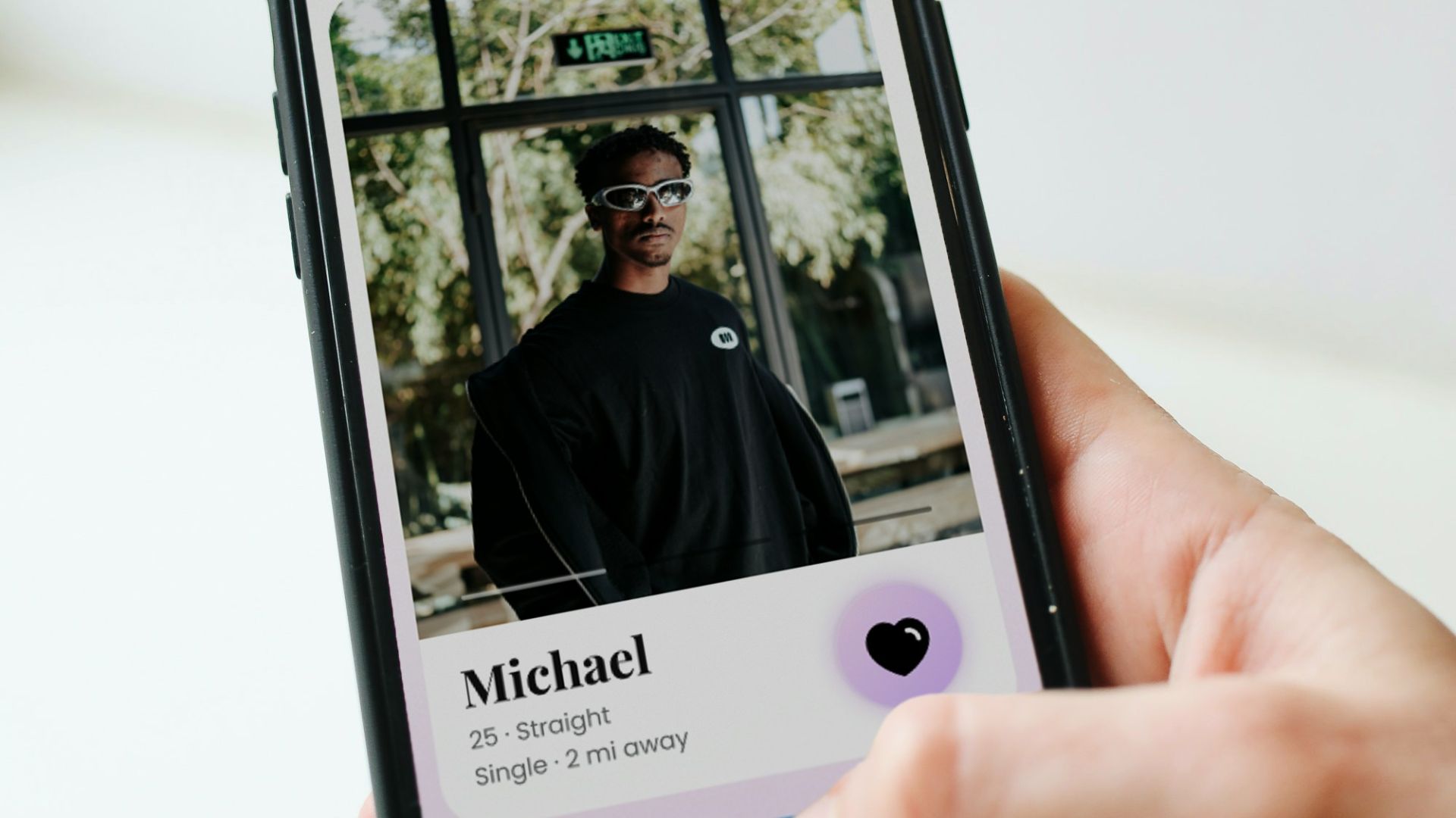 a person holding a cell phone with a picture of a man on it