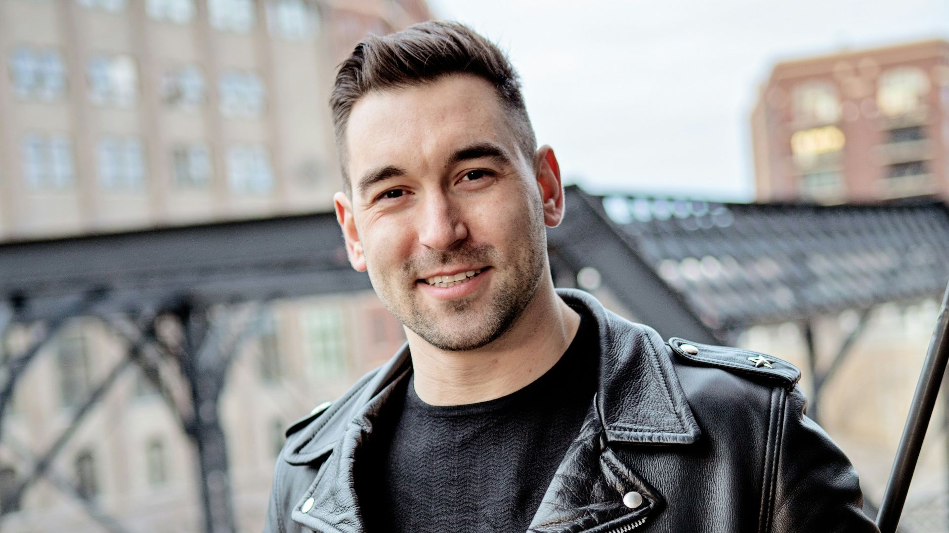 one unknown celebrity standing near black barrier