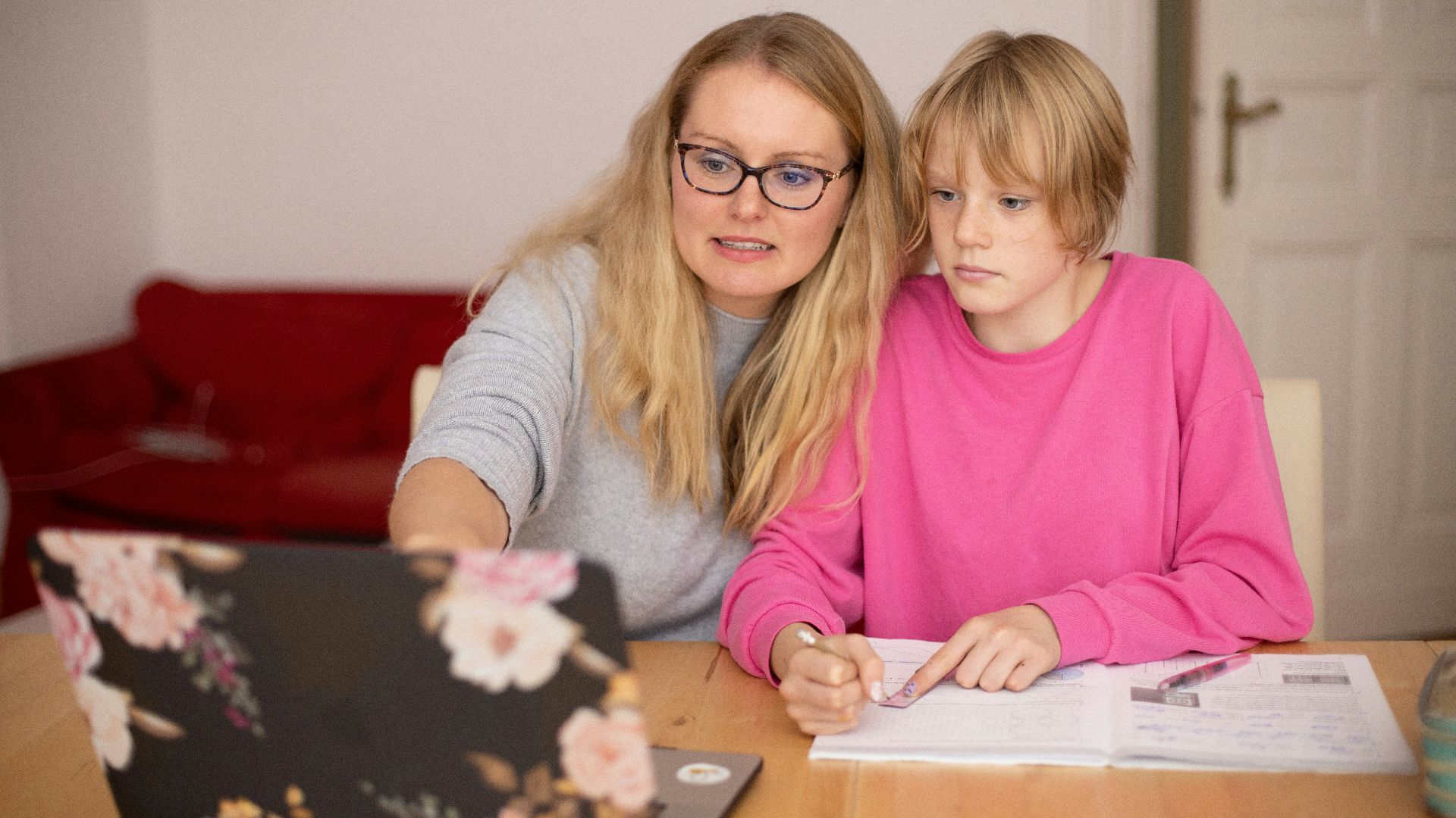 girl in pink sweater beside girl in gray sweater