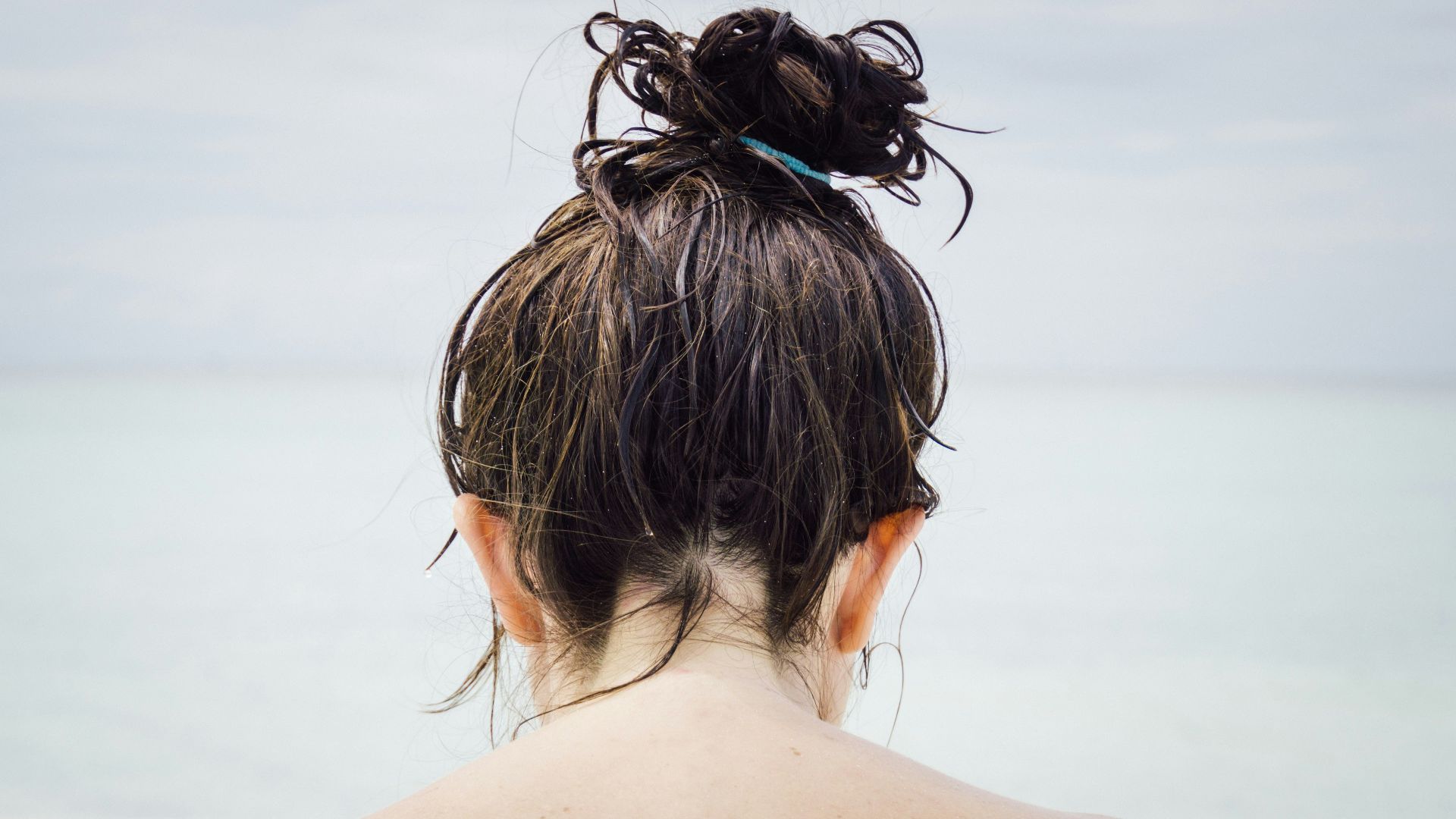 woman facing seashore