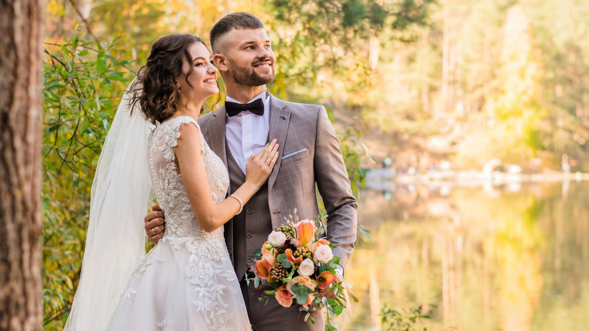 man in gray suit and woman in white wedding dress