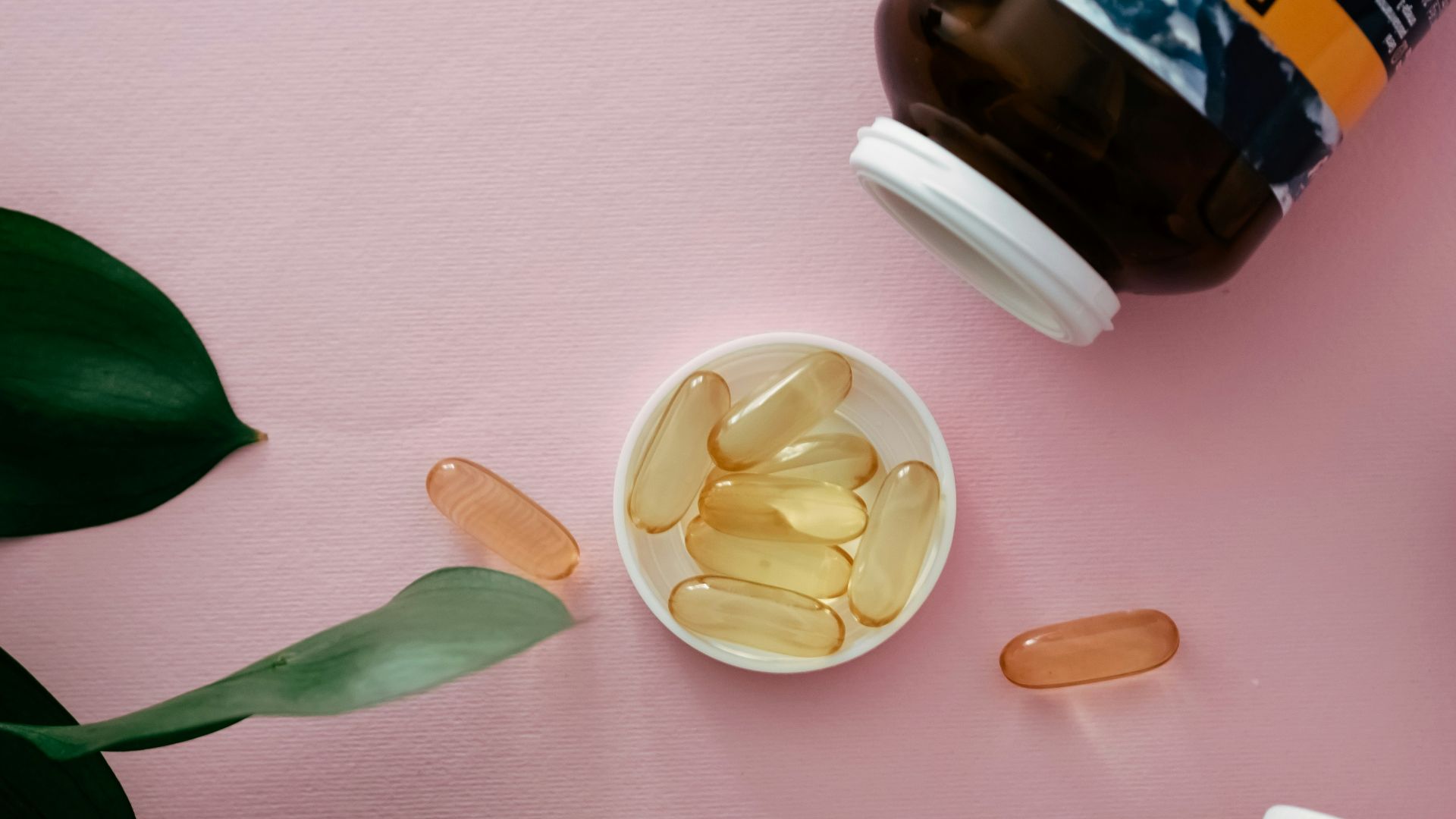 a bowl of fish oil next to a bottle of fish oil