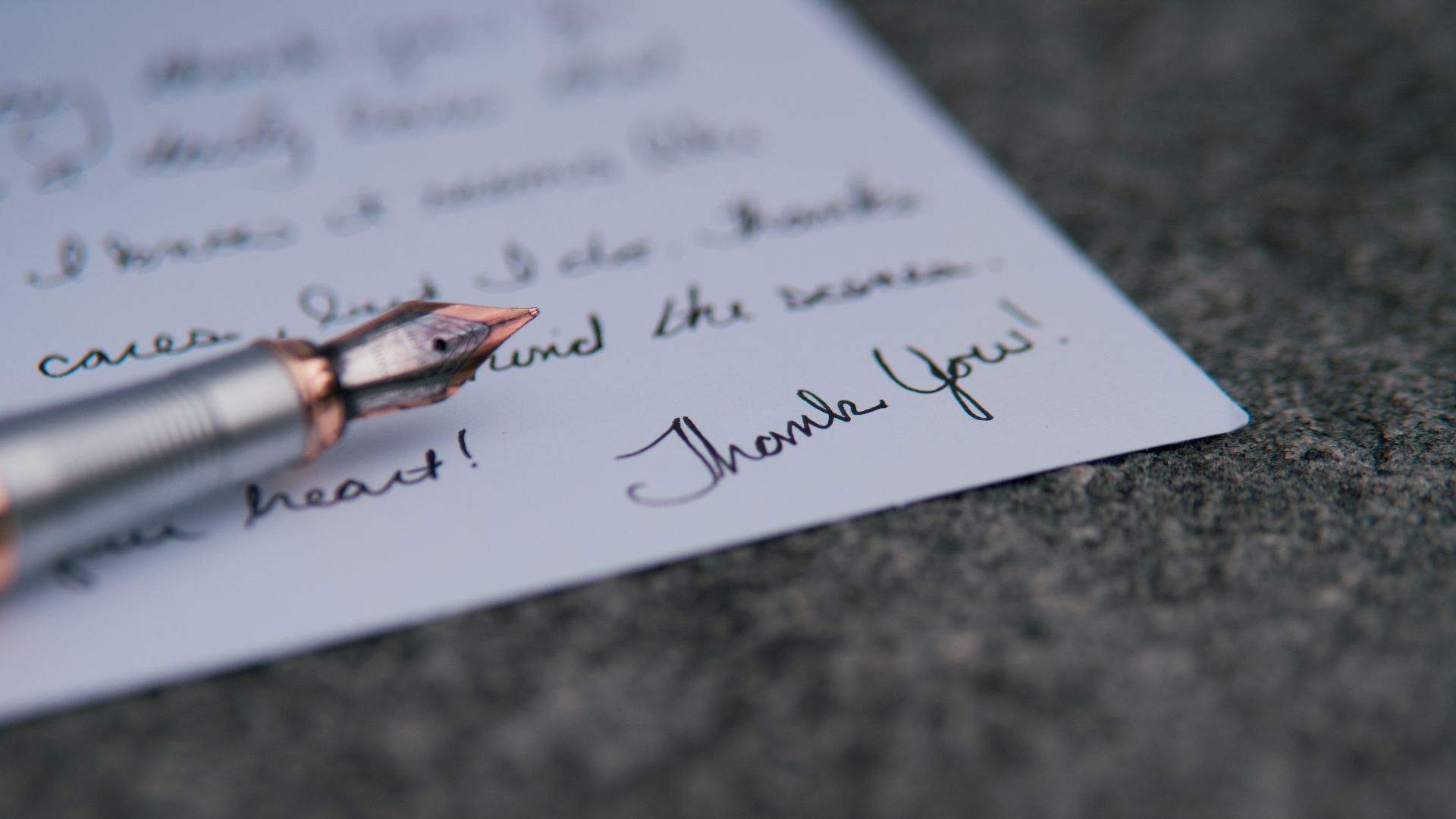 a pen on top of a piece of paper with writing on it