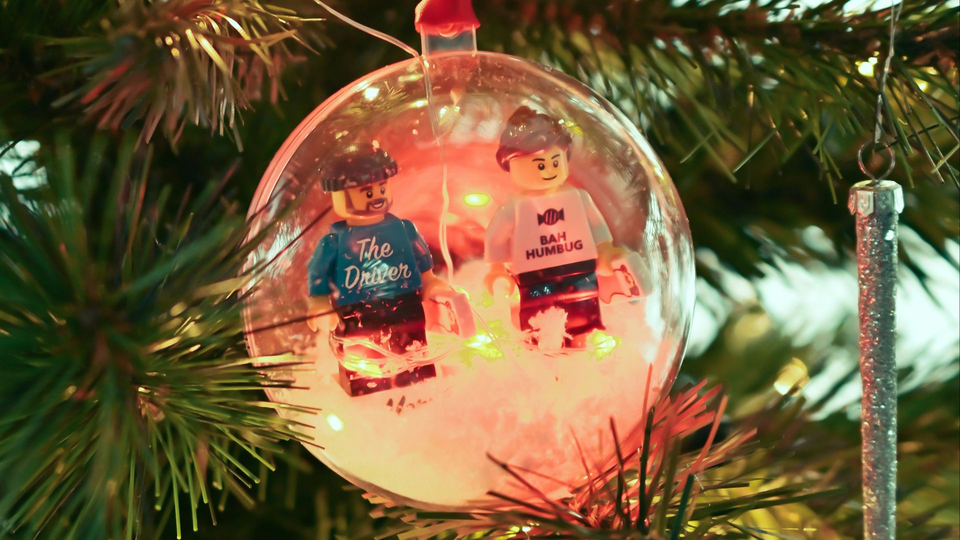 a glass ornament hanging from a christmas tree