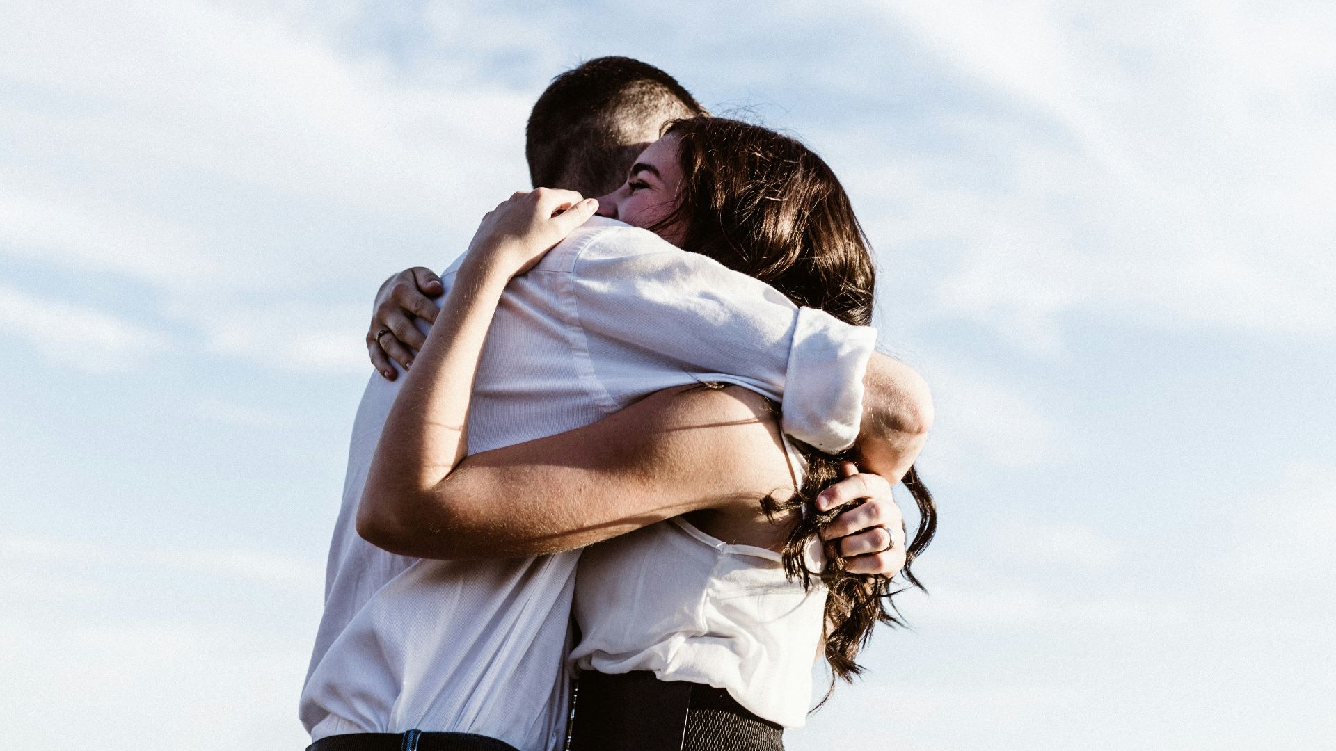 man and woman hugging each other photography