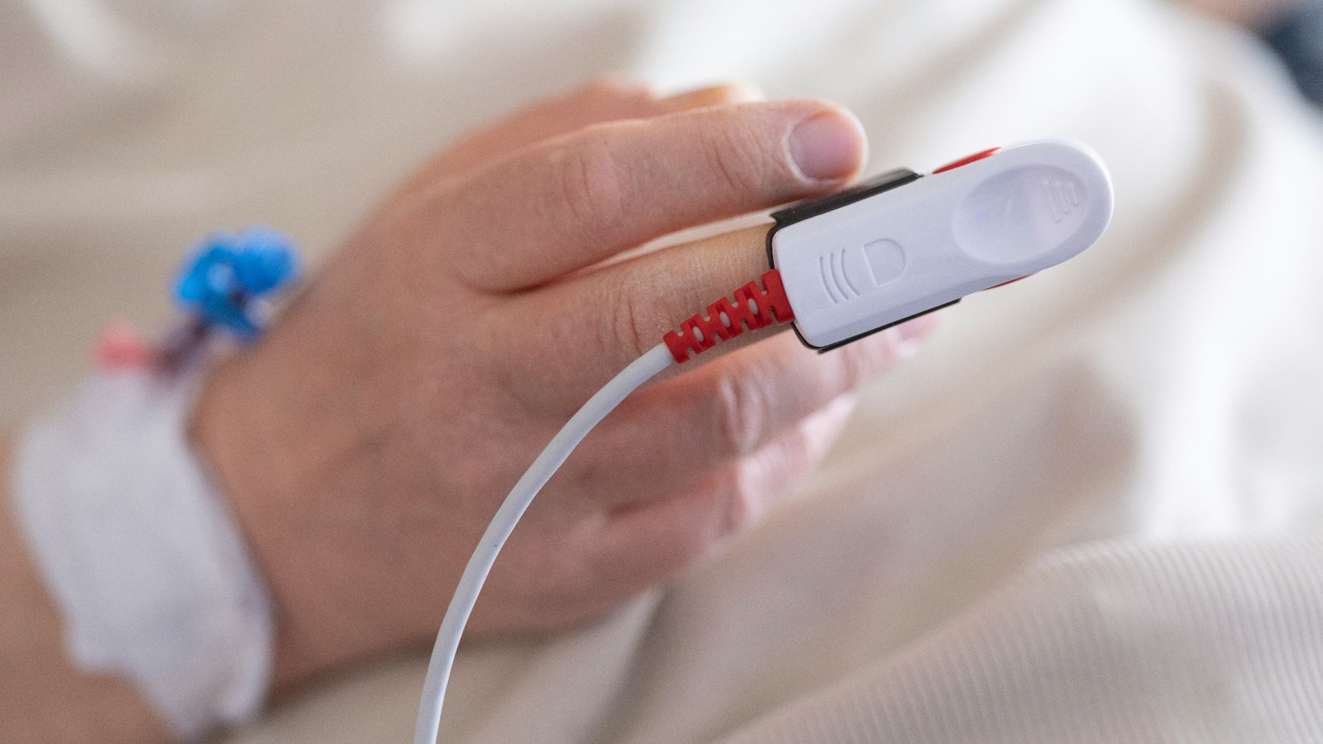 a person in a hospital bed holding a device