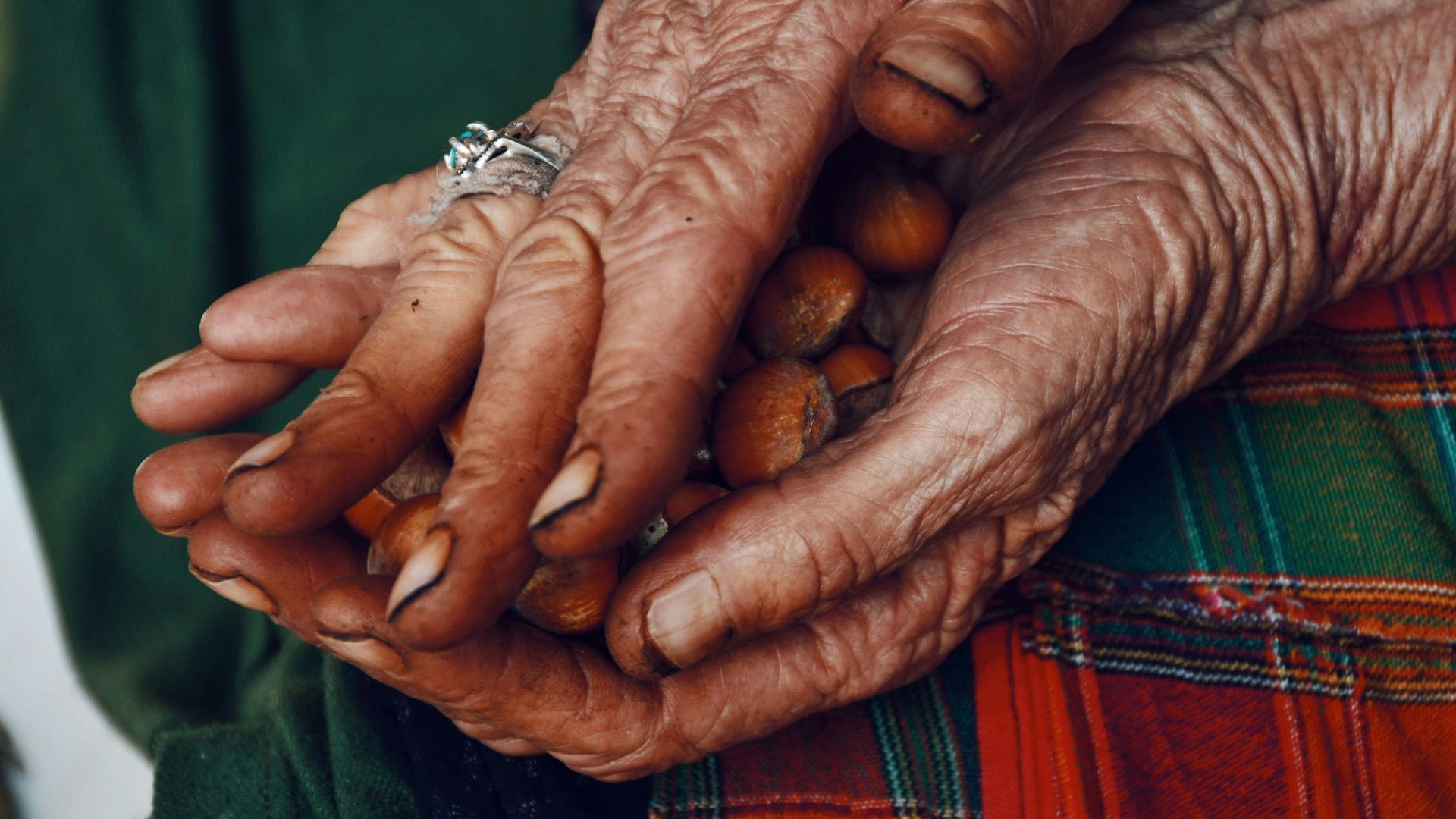 an old woman holding nuts in her hands