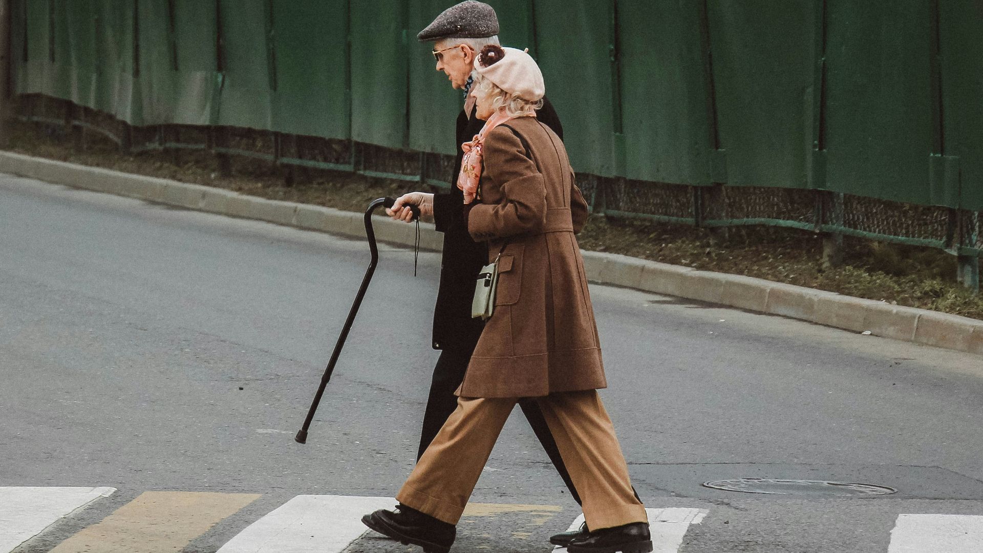 man and woman walking on pedestrian line during daytime