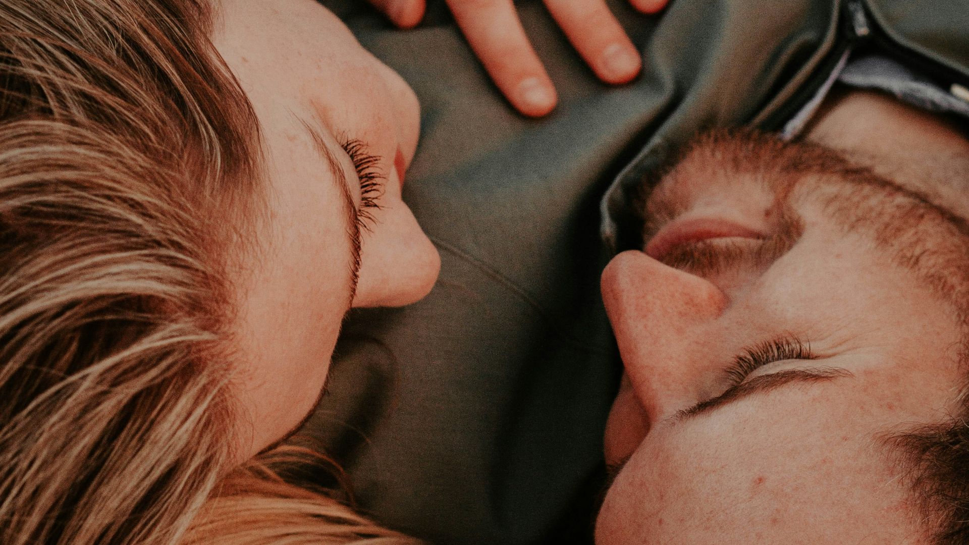 a woman stares into a man's eyes lovingly
