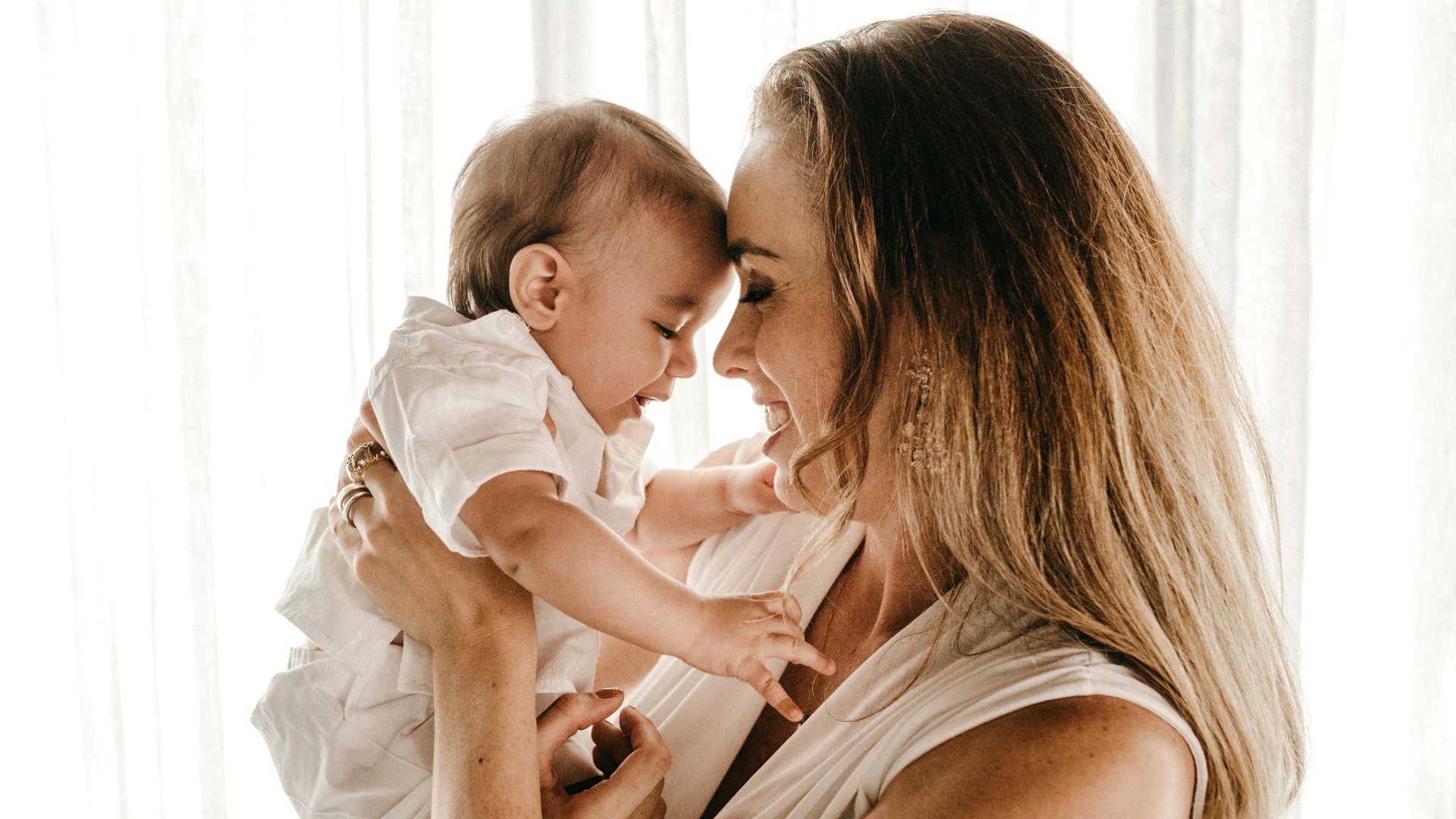 smiling woman carrying baby