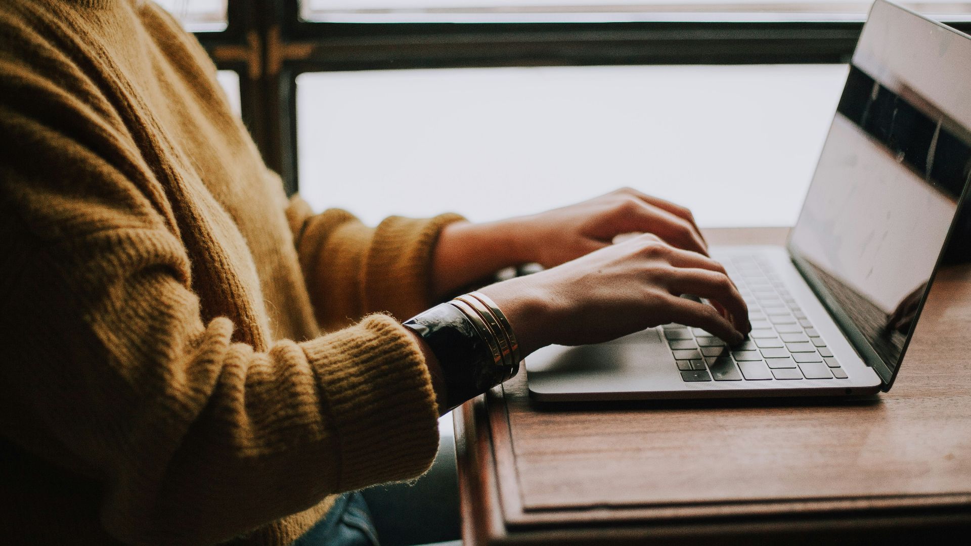 person sitting front of laptop