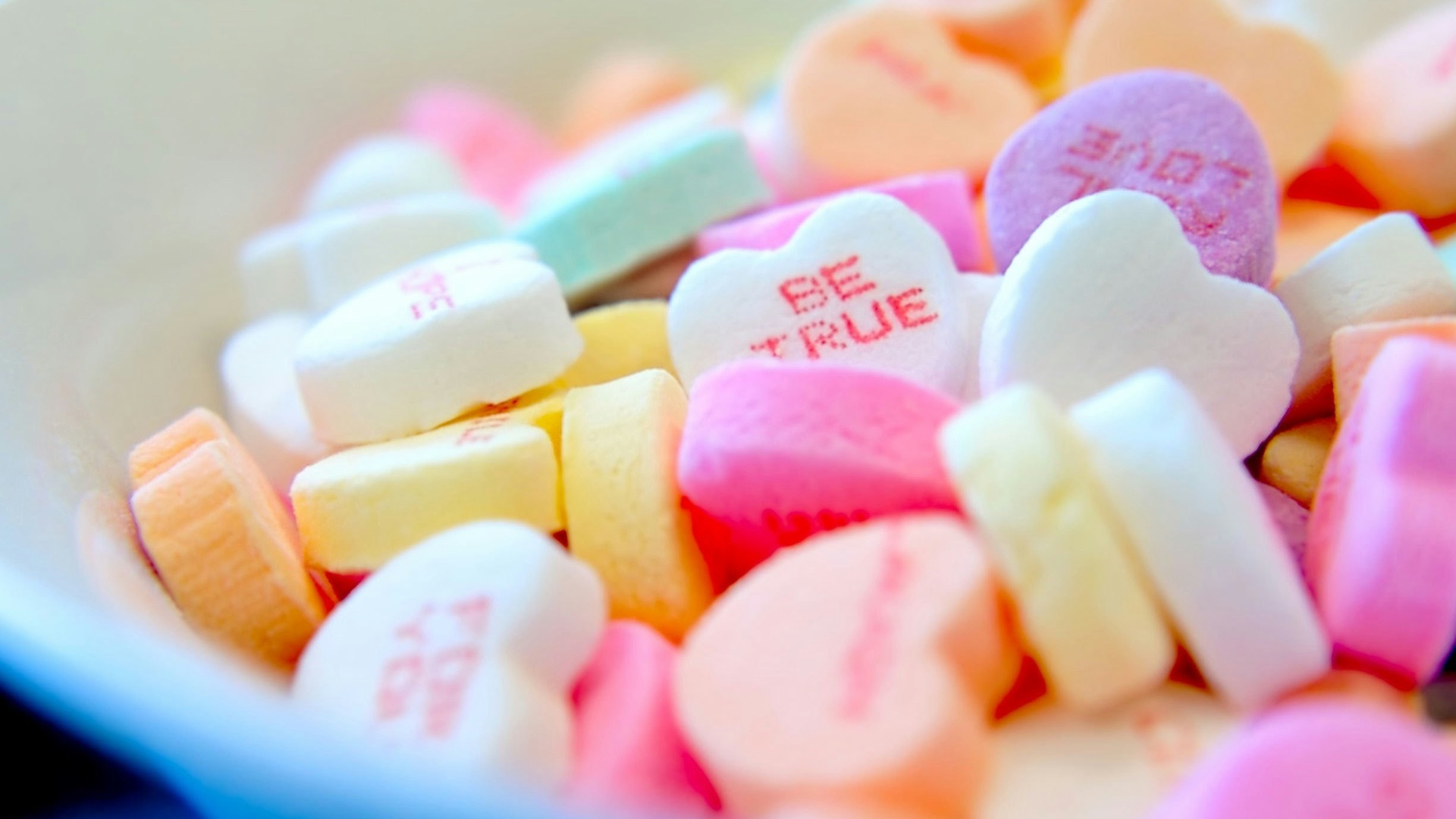assorted hear-shape candies on white bowl