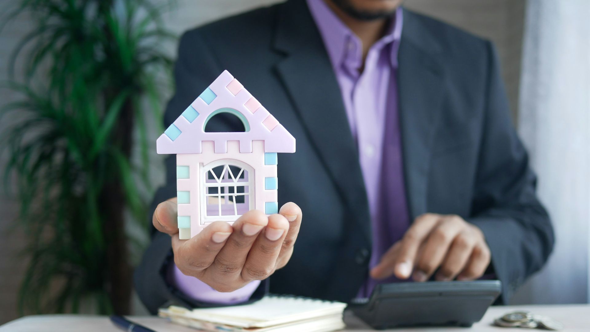 man in purple suit jacket using laptop computer