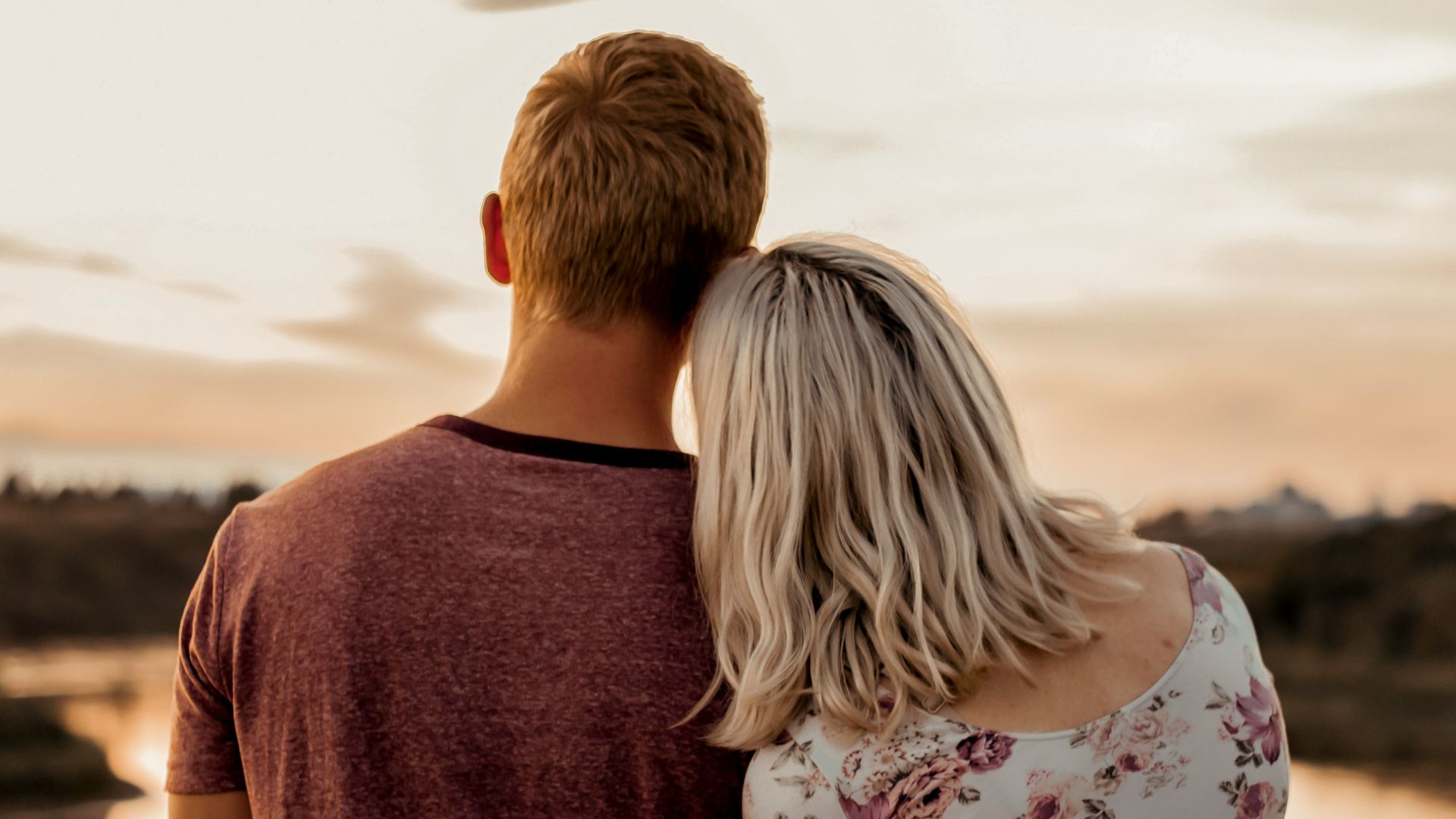 man and woman standing on brown field during daytime
