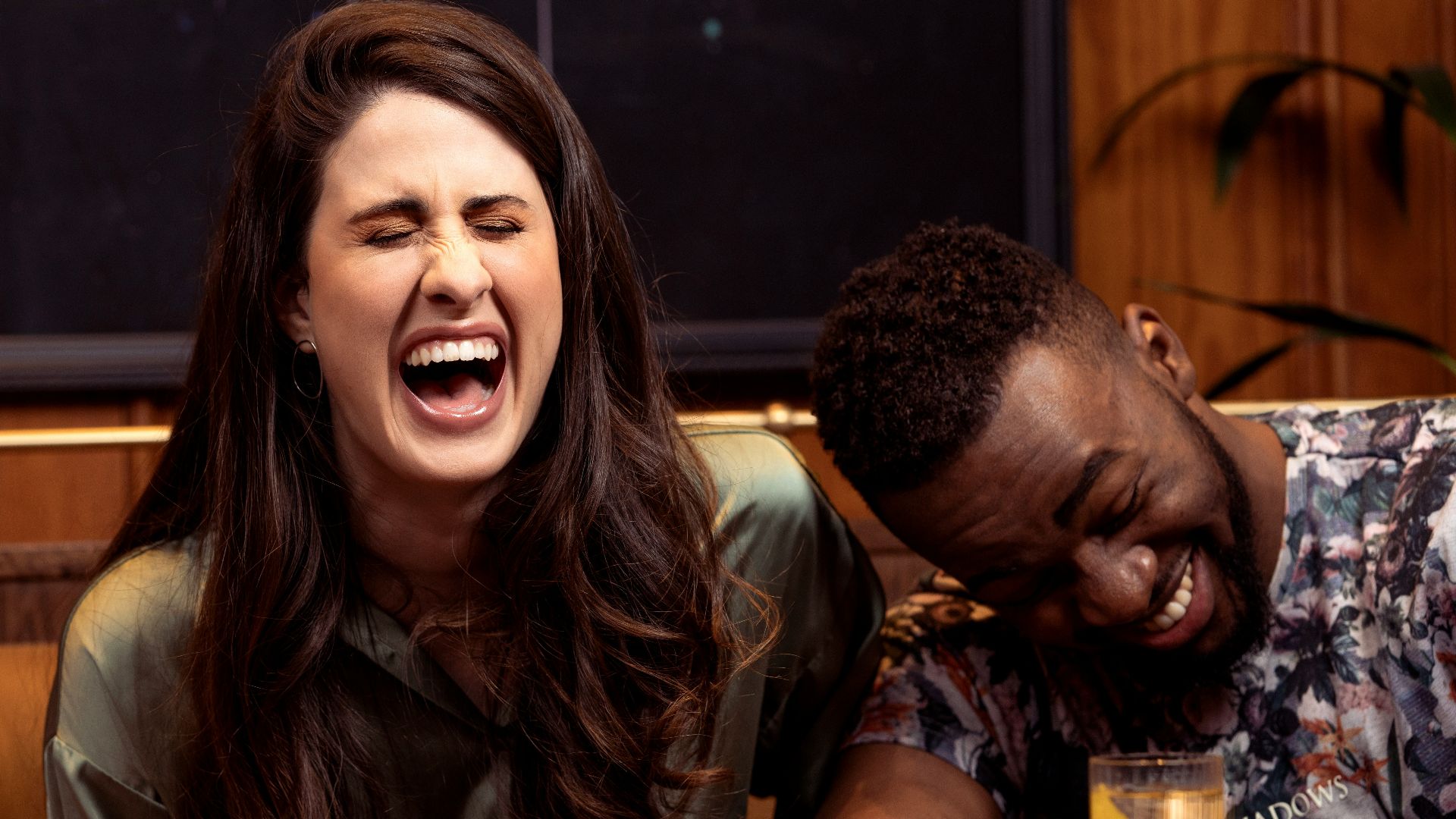 a group of people sitting around a table with drinks