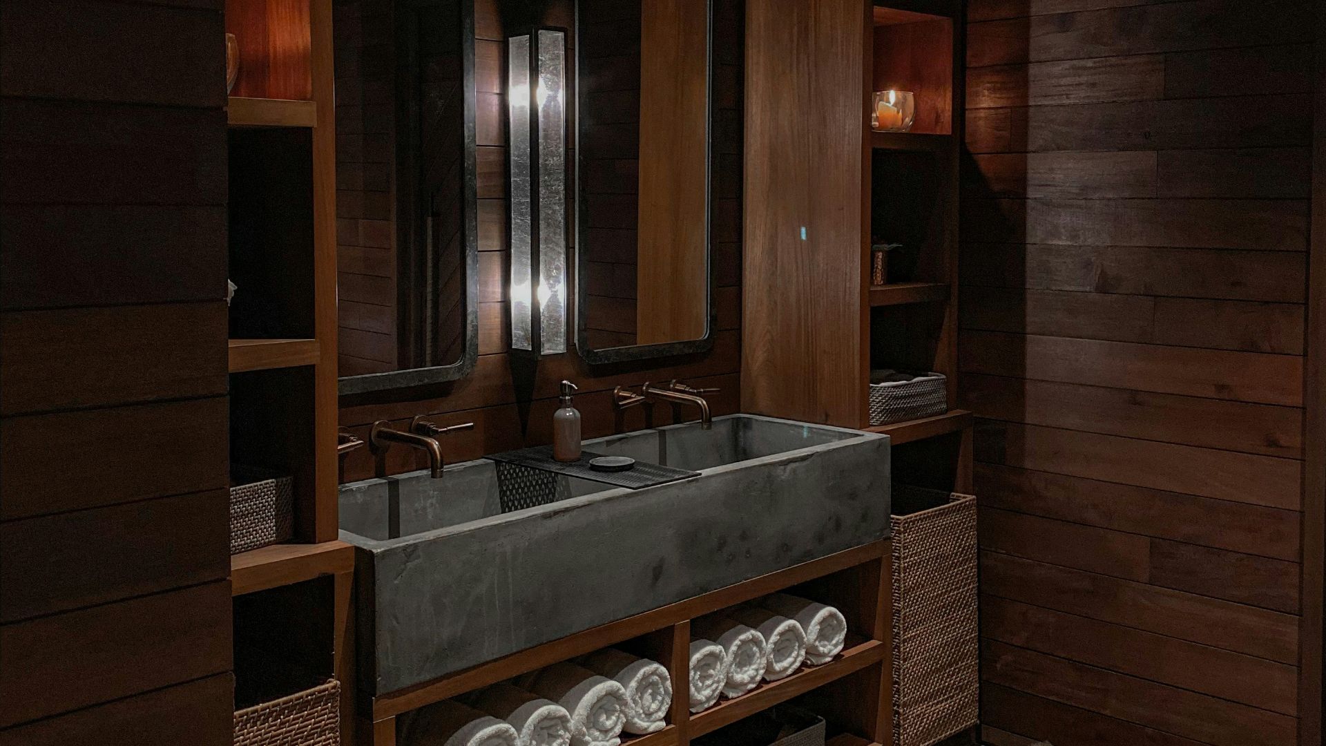 a bathroom with a large sink and wooden walls