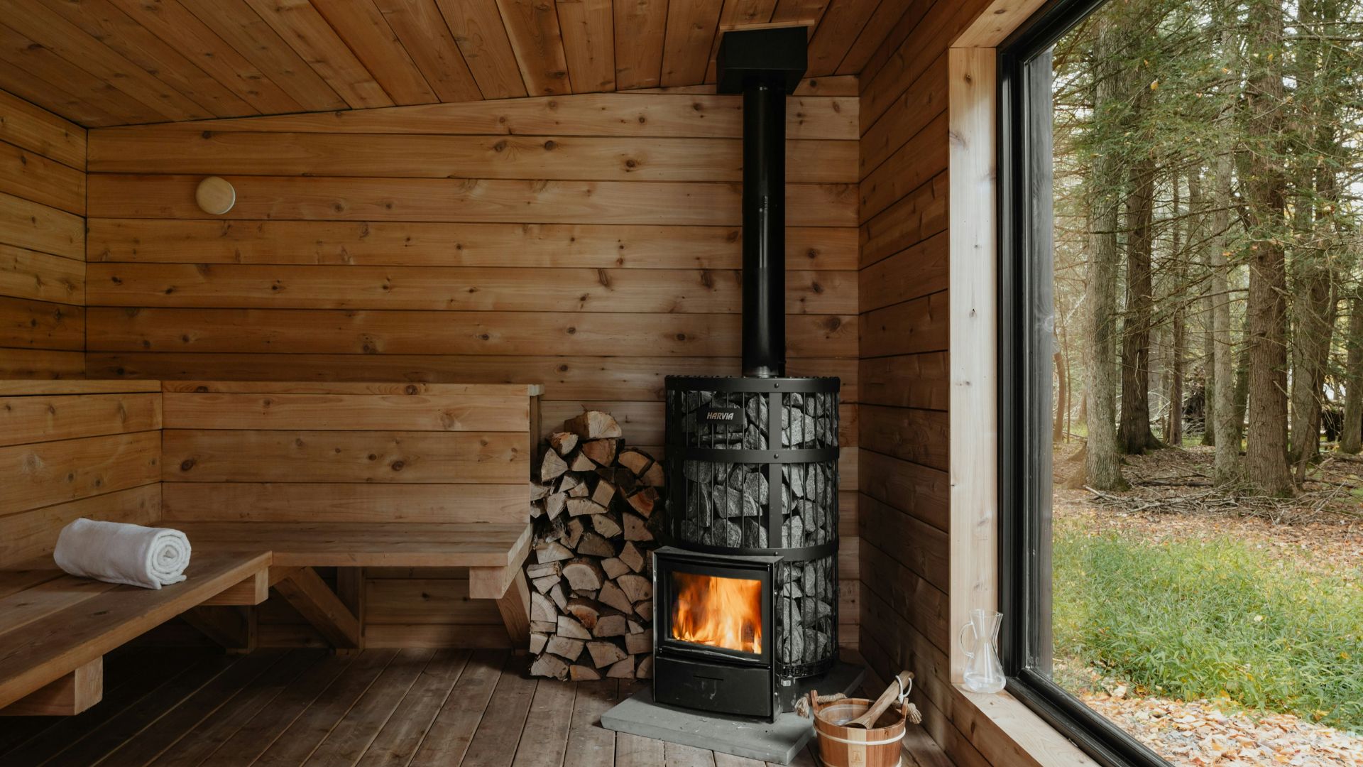 A wood burning stove inside of a wooden cabin