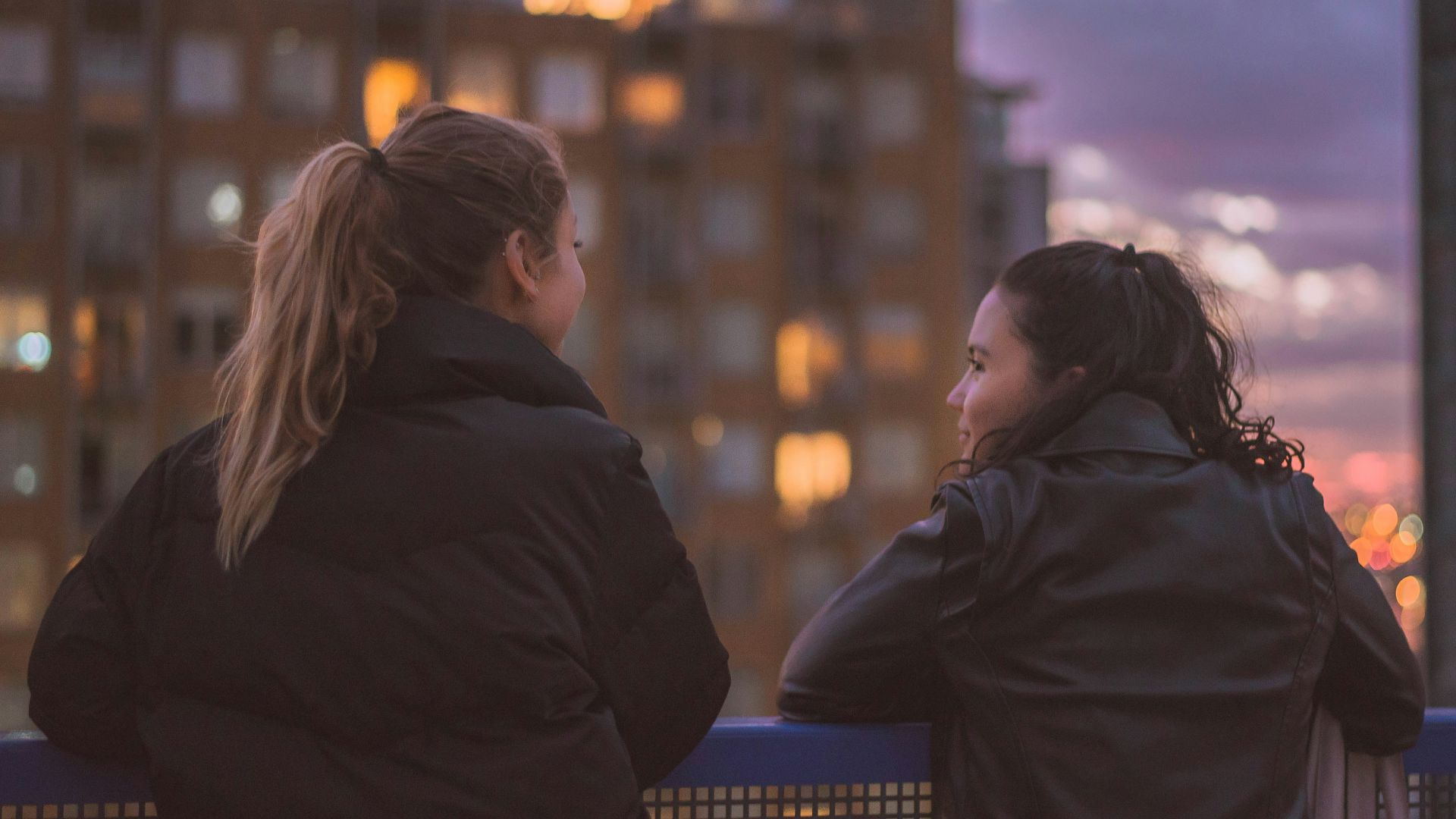 two women standing near railings