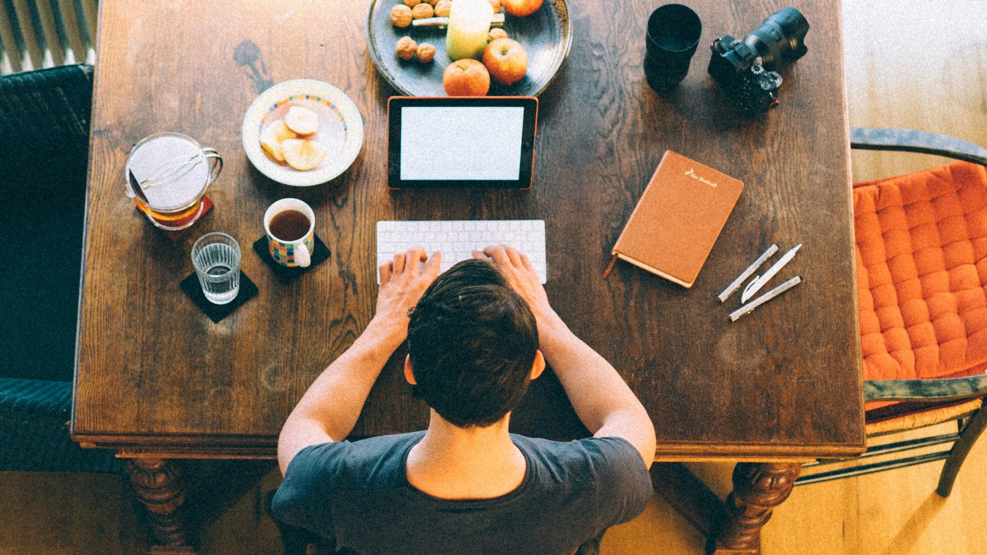 man typing on keyboard inside room