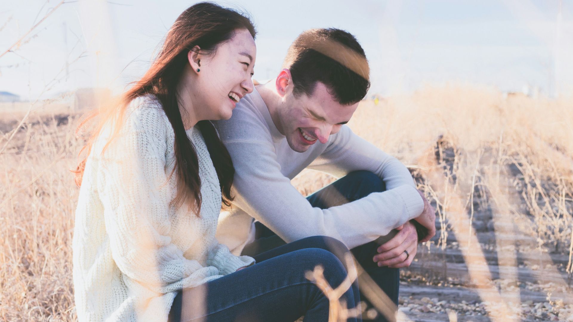 photo of man and woman laughing during daytime