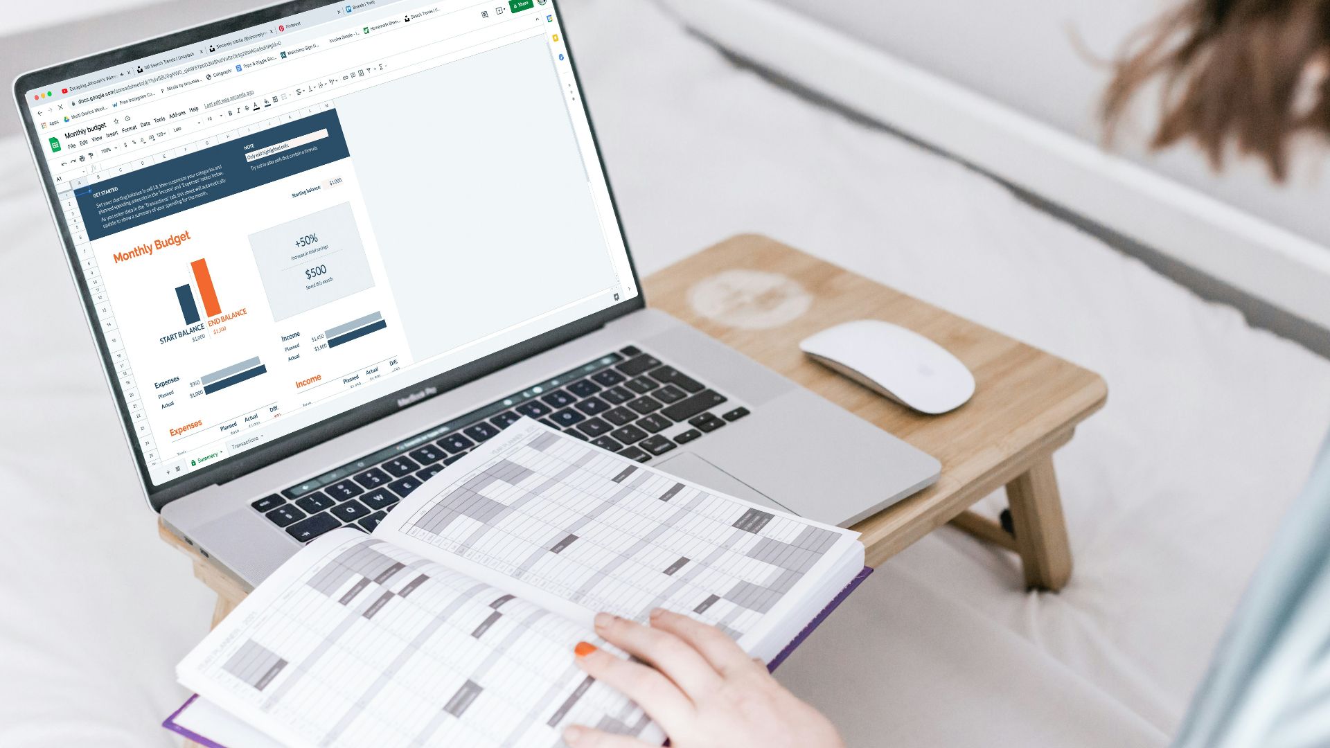 a person sitting on a bed with a laptop