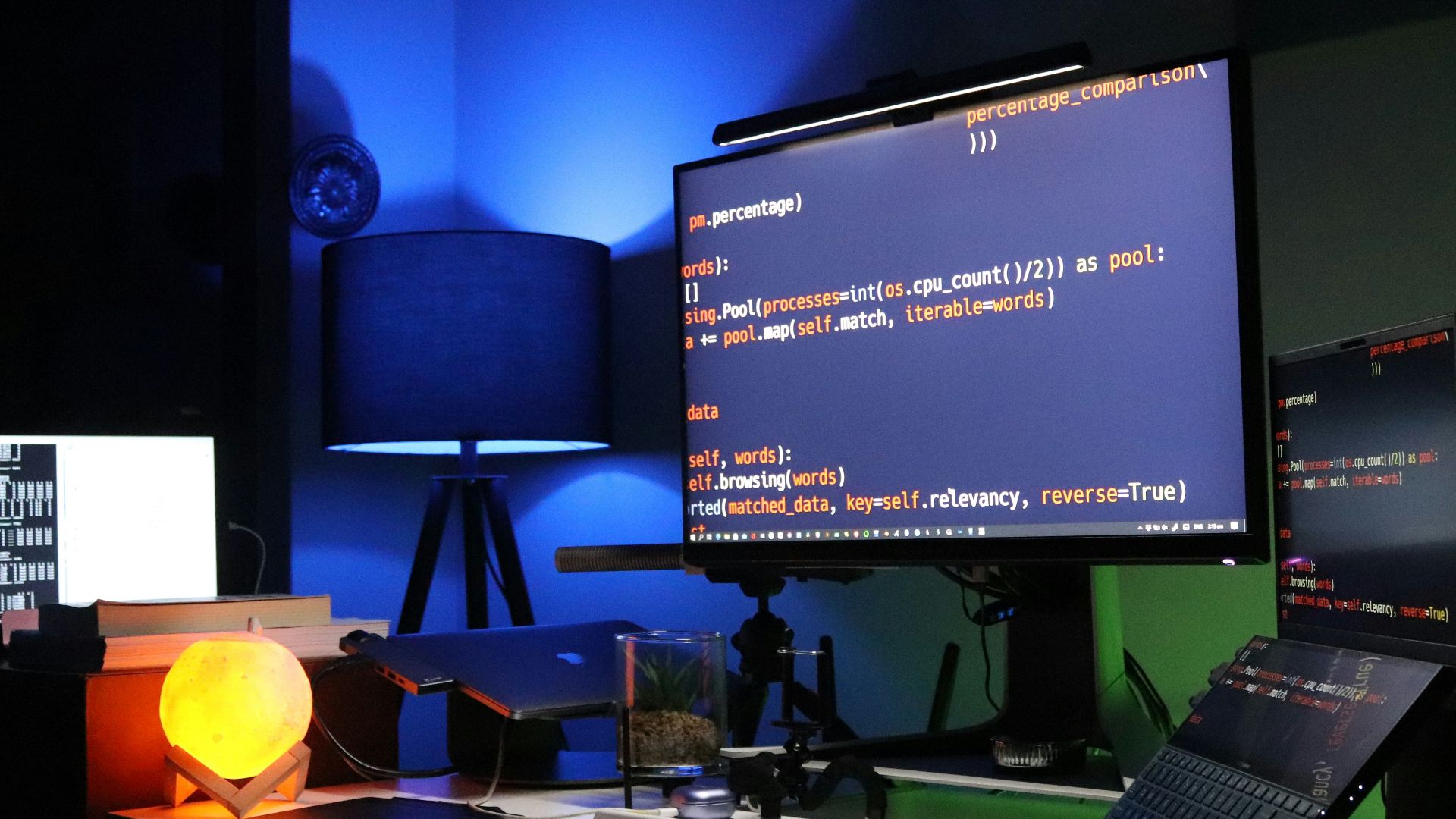 black flat screen computer monitor on green desk