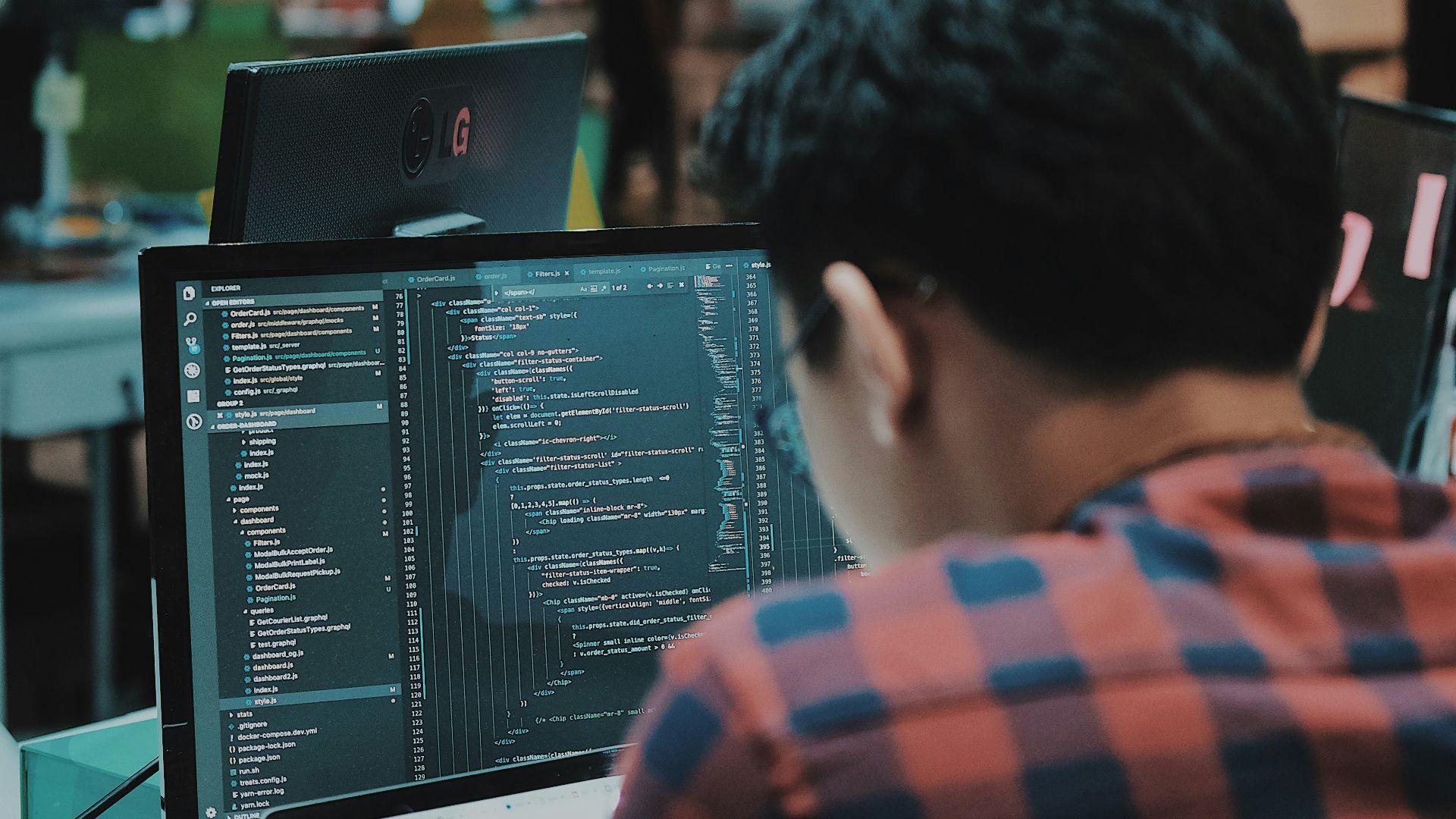 sitting man using gadget in room