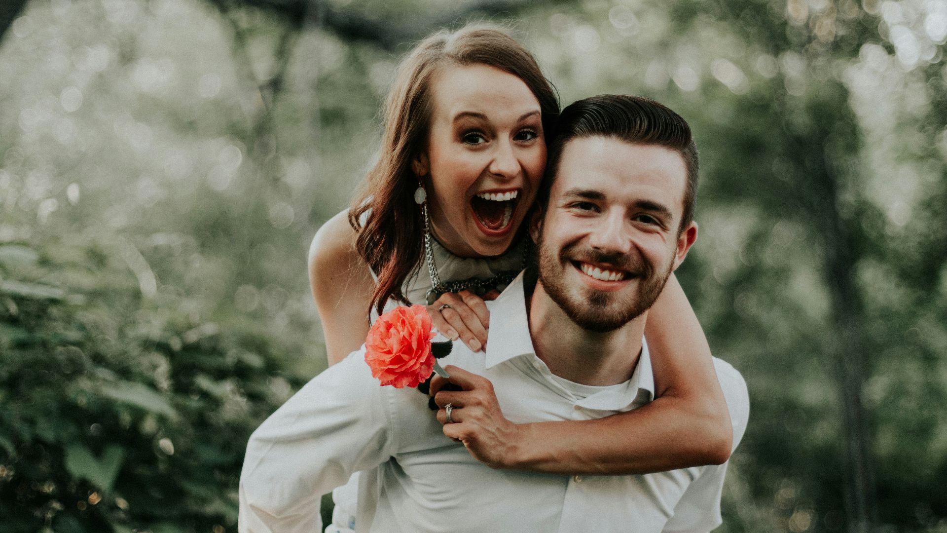 woman riding on back of man