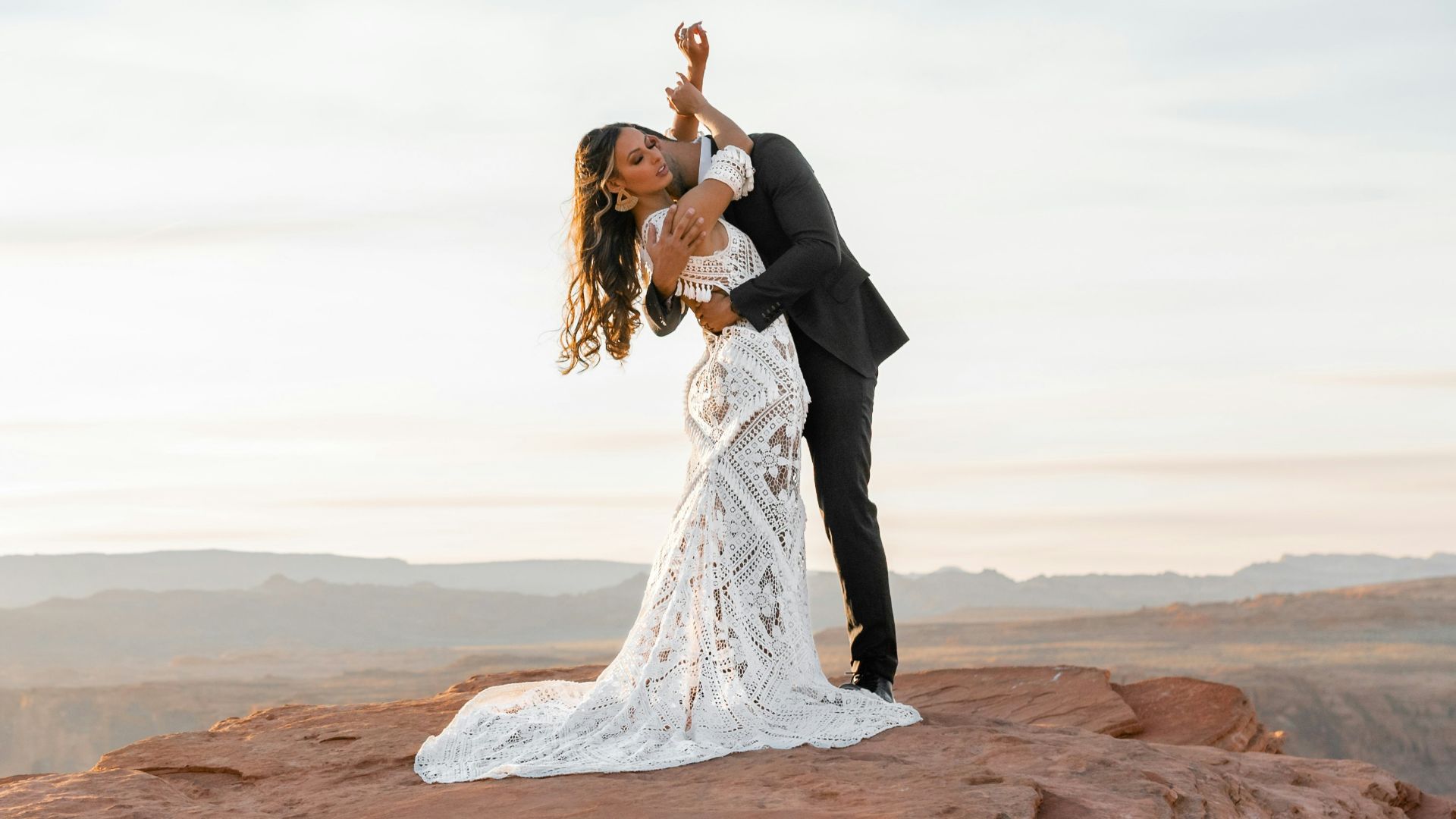 man and woman kissing on brown rock formation during daytime