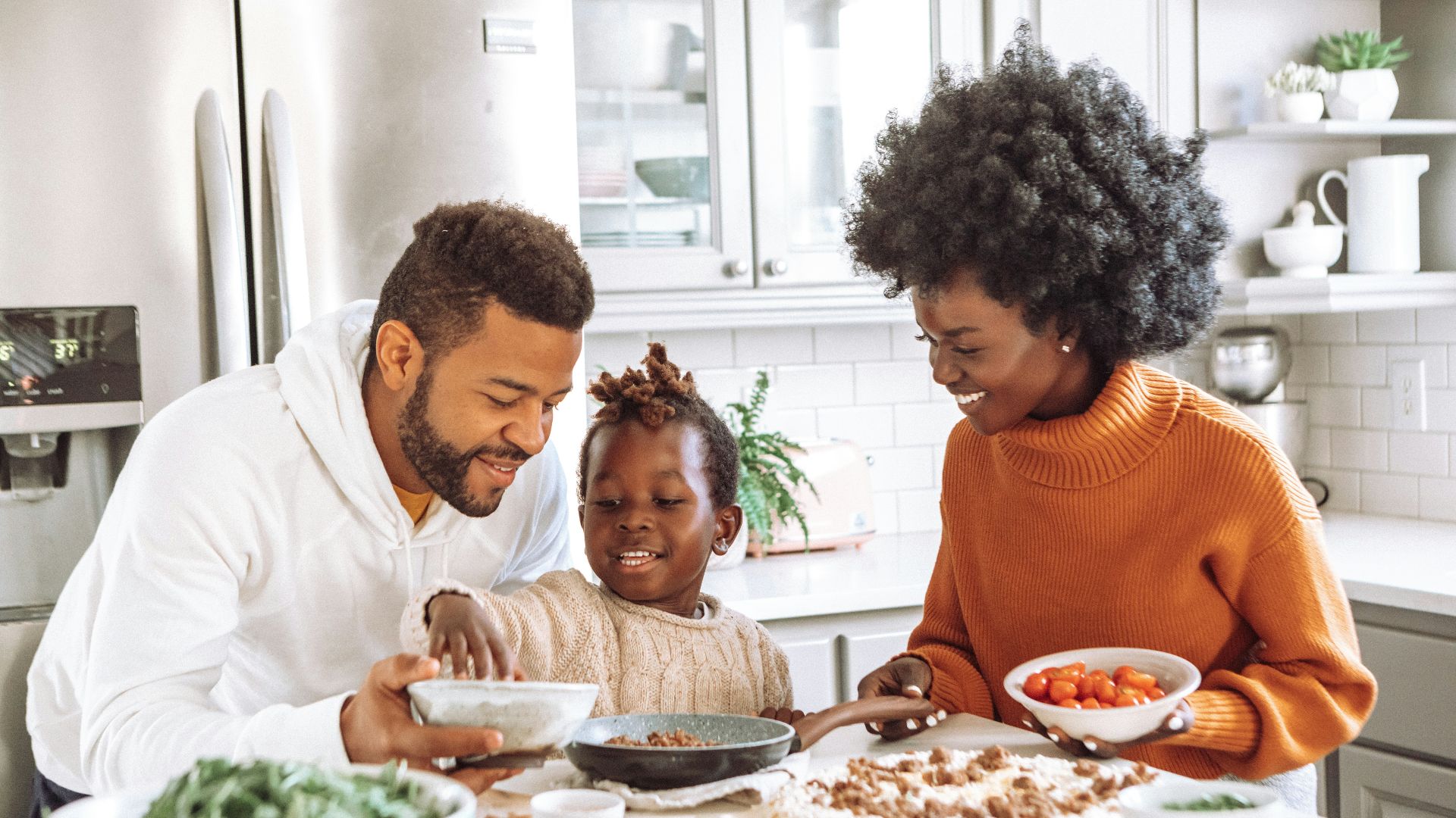 man in white dress shirt sitting beside woman in orange sweater