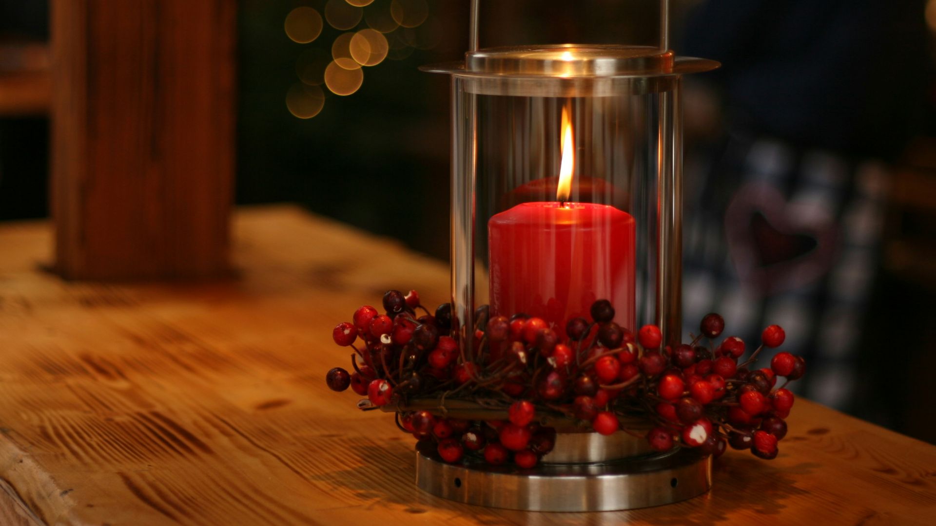 red lighted candle on brown wooden frame