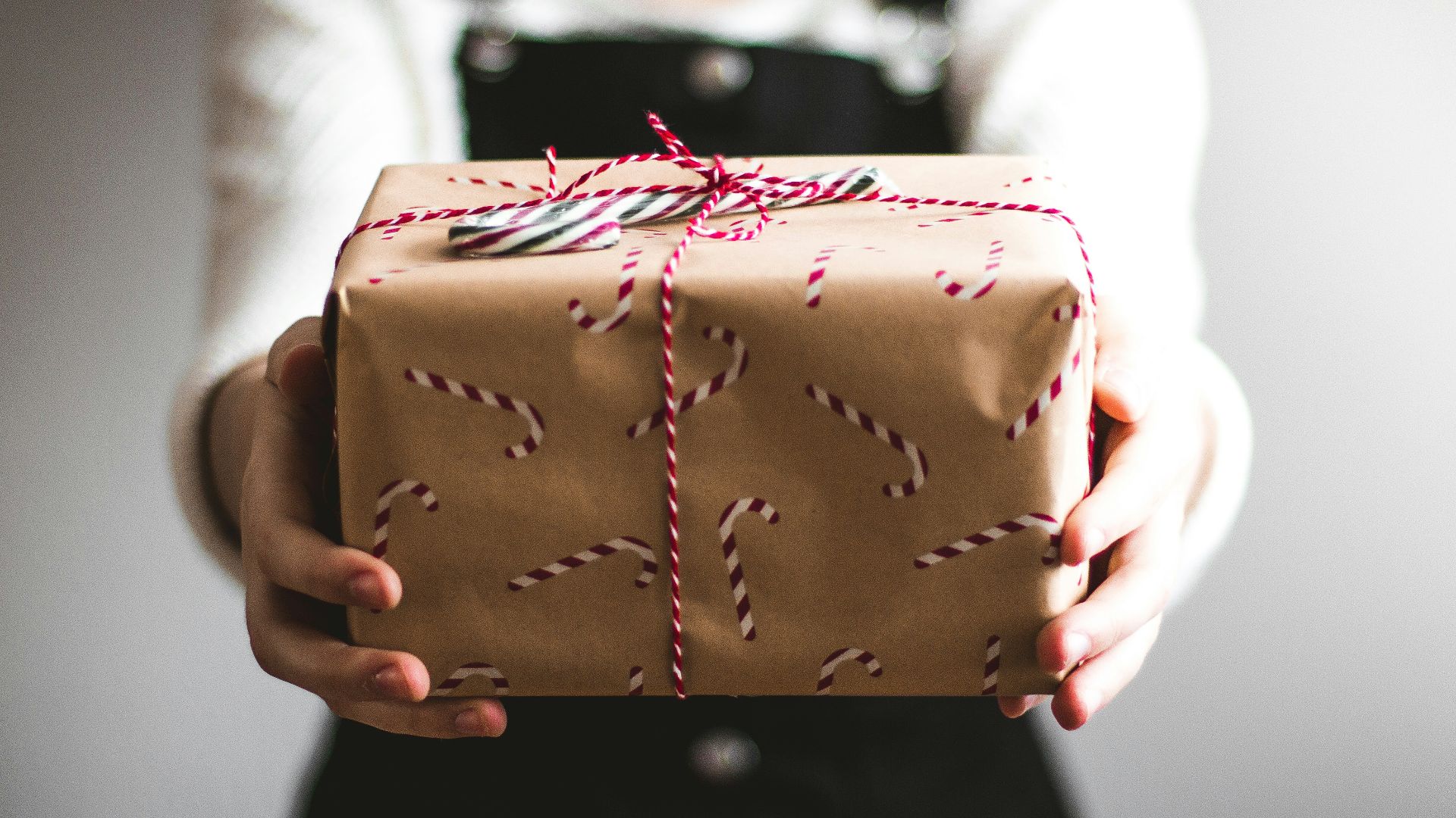 person showing brown gift box