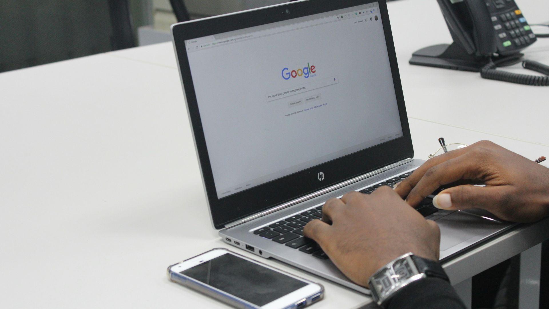 person typing on gray and black HP laptop