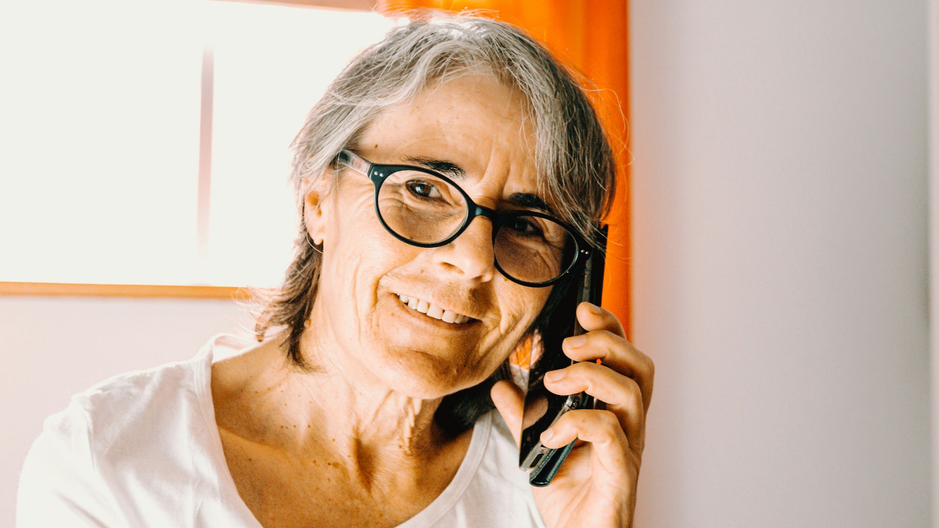 woman in white scoop neck shirt wearing black framed eyeglasses