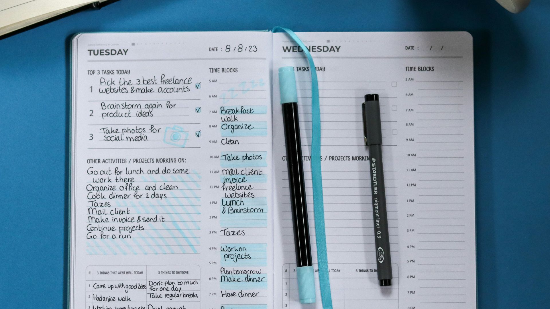 a notebook with a pen and a cup of tea